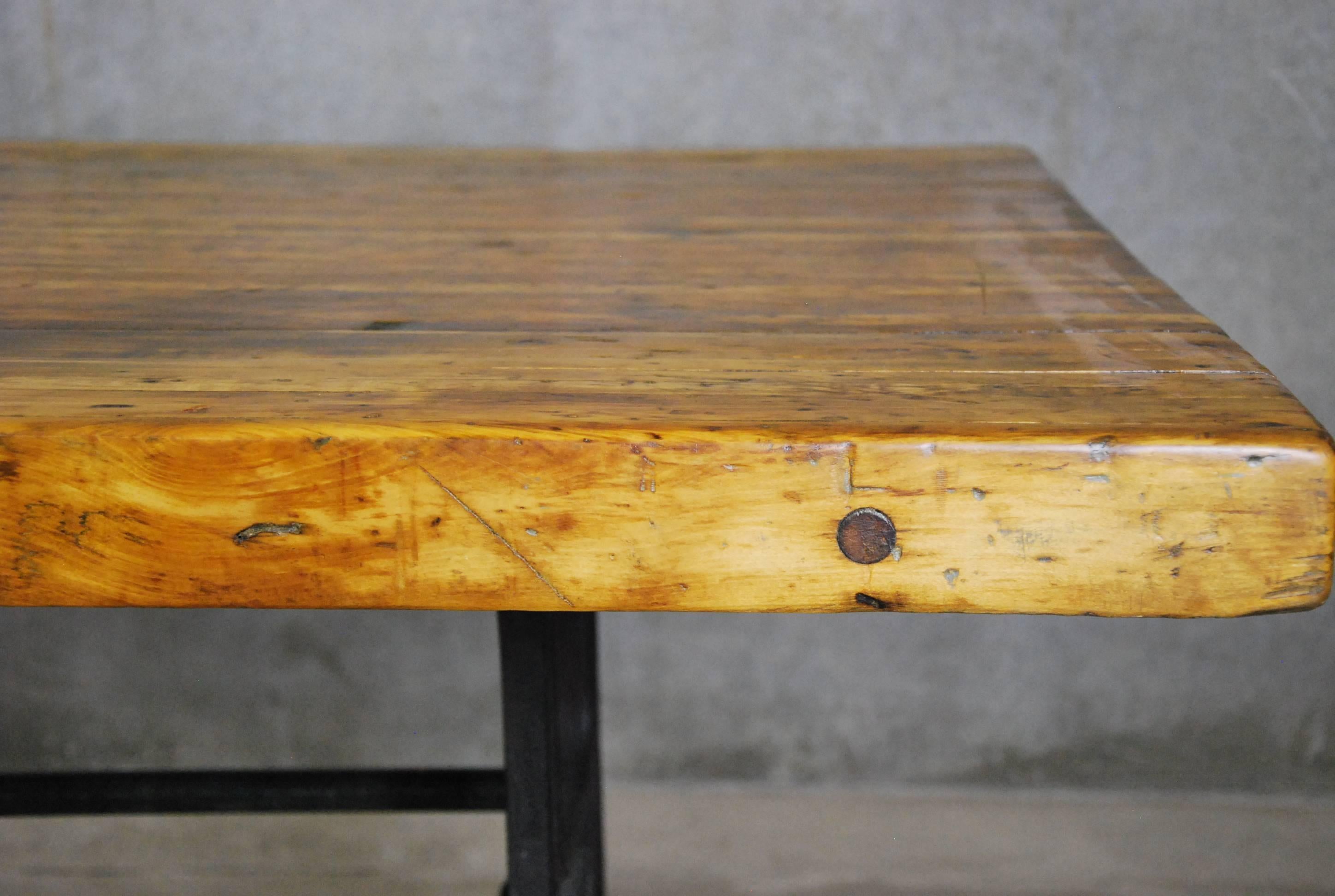 We found this rare, 1920 maple tabletop in a factory outside Chicago. Its cast iron base was salvaged from an old Industrial machine in that same factory. The merger of these two antique elements has resulted in a beautiful, 10-foot long