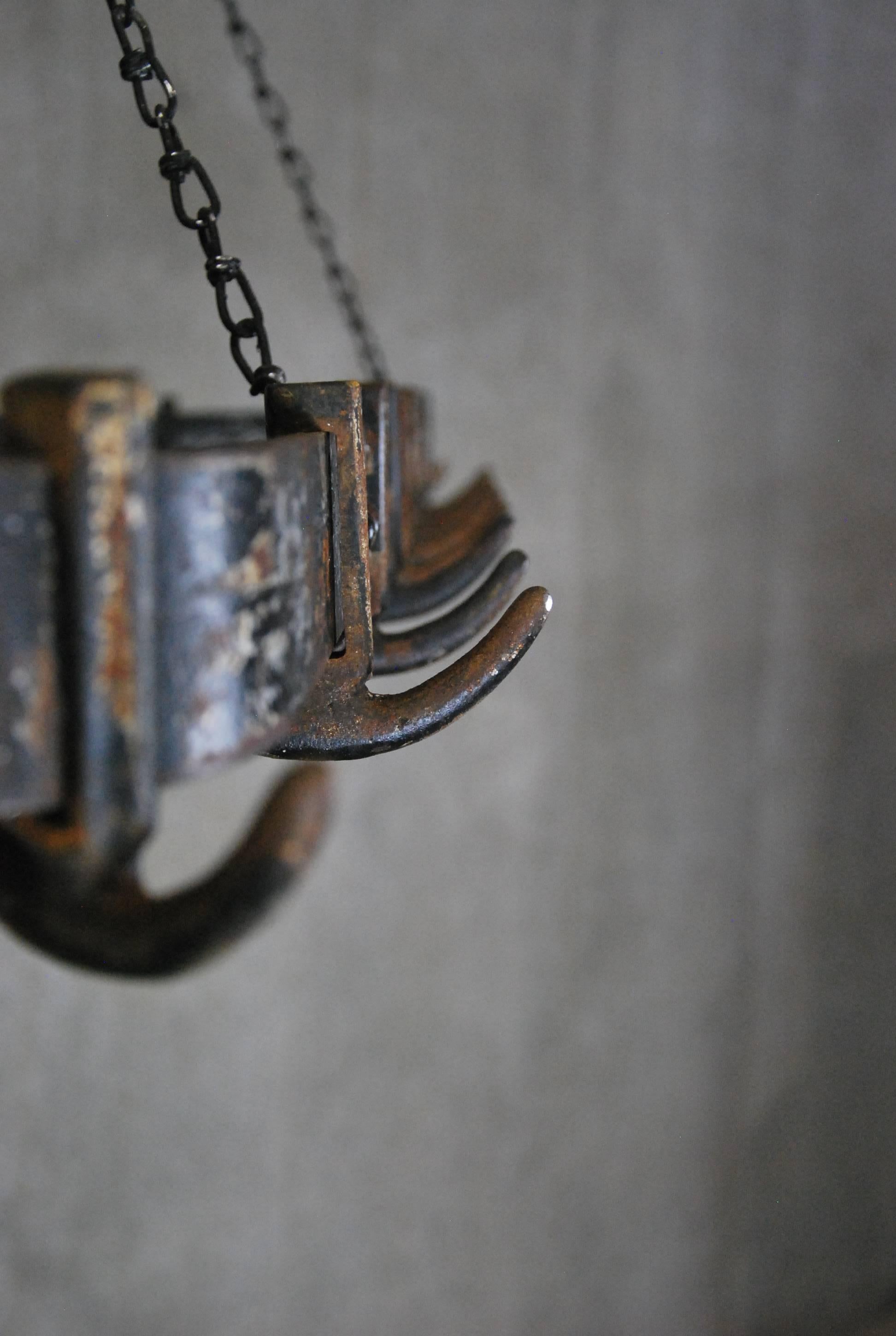 Really nice complete pot rack found in a commercial kitchen in a demolition of several old warehouses in Montreal.
This unit retains some of it's old black paint and adjustable chain.

