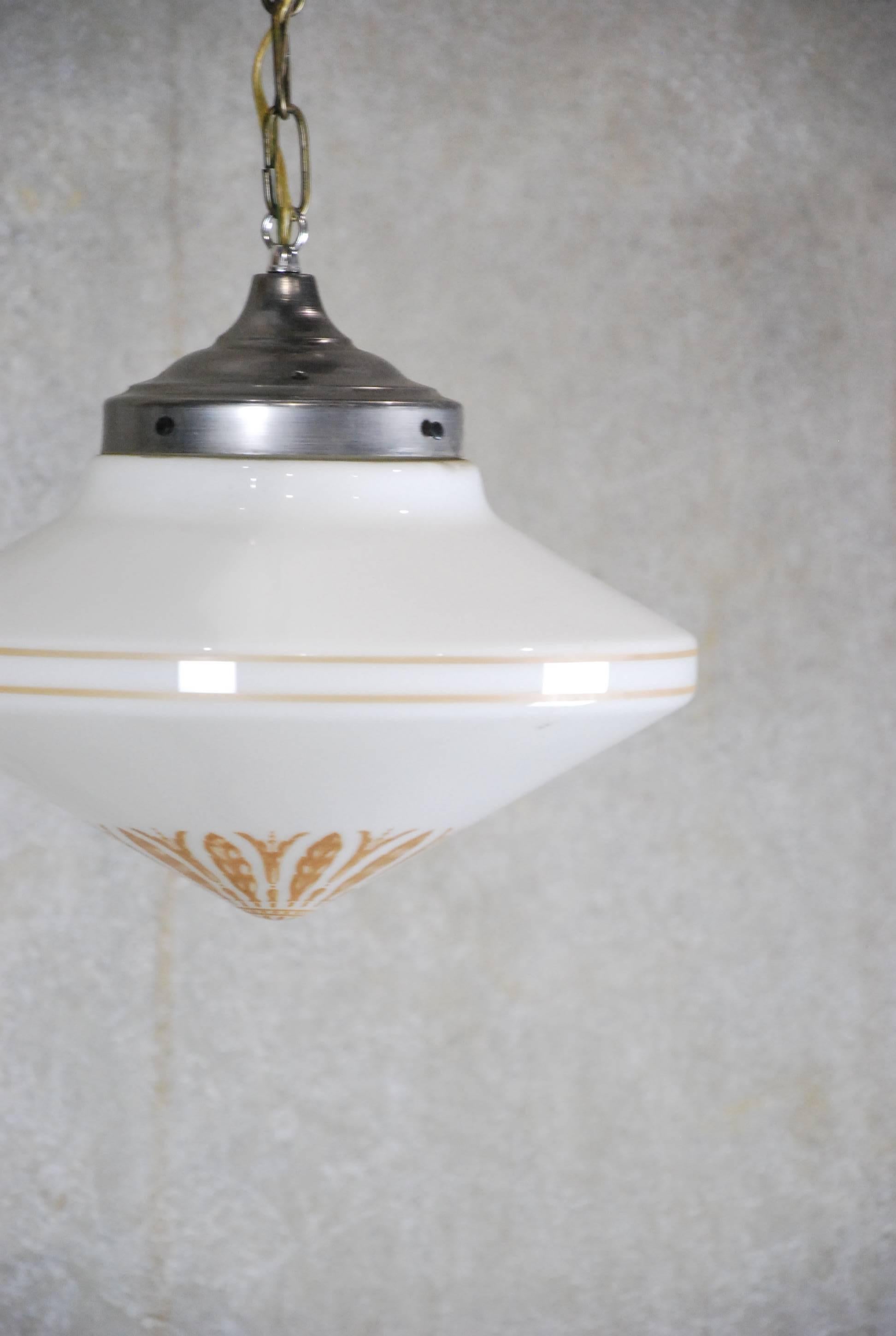 Art Deco-style pendant lights with original fitters and ceiling caps. Found in upper New York state. All re-wired and CSA approved; some adjustment to chain lengths available upon request. Quantity of 15 in stock. Price per item.
