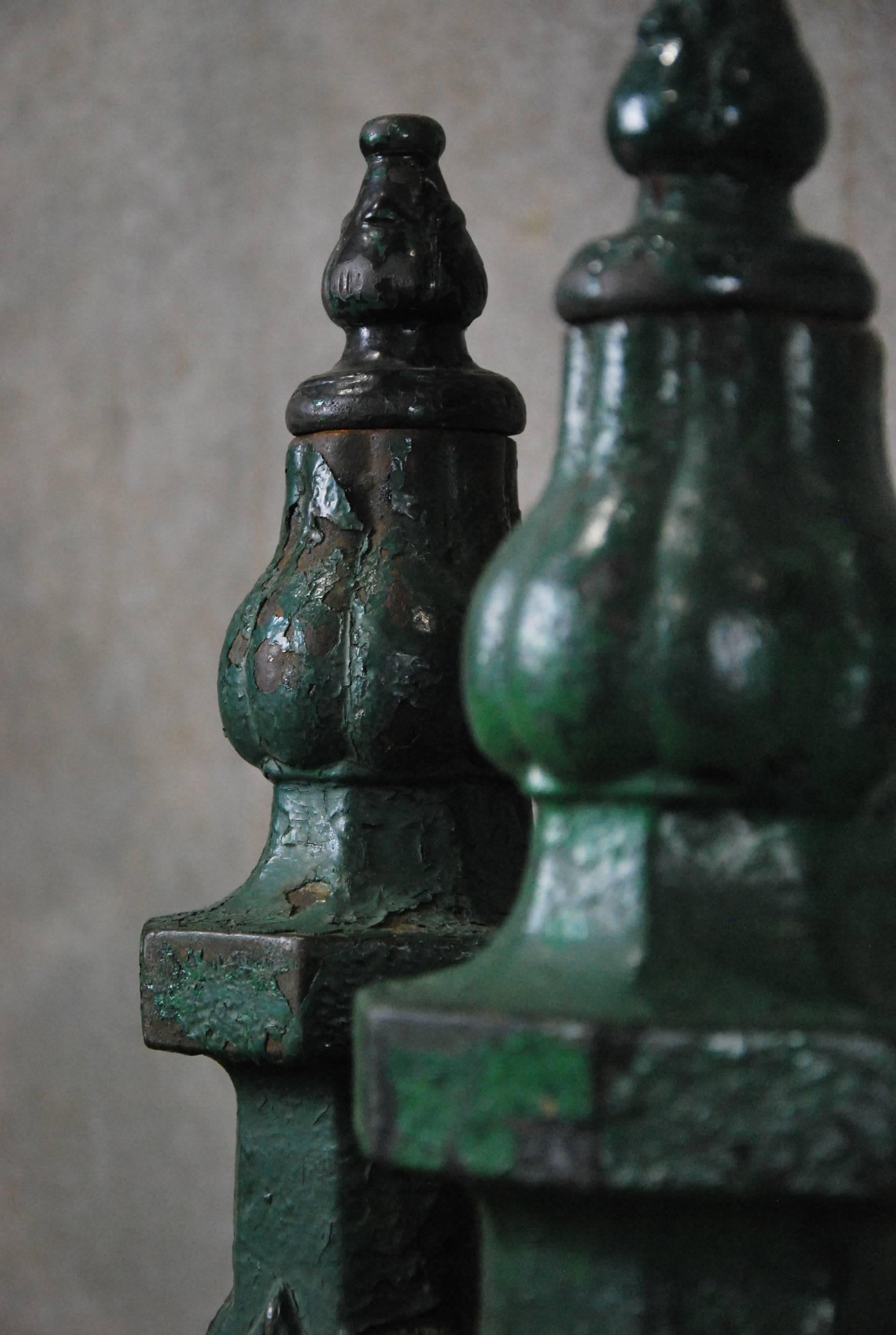 Very nice and complete pair of newel post with strong French motif in oxidized green paint over cast iron.

The post are nice and tall allowing for easy implementation to any design project.

Found in Chicago.