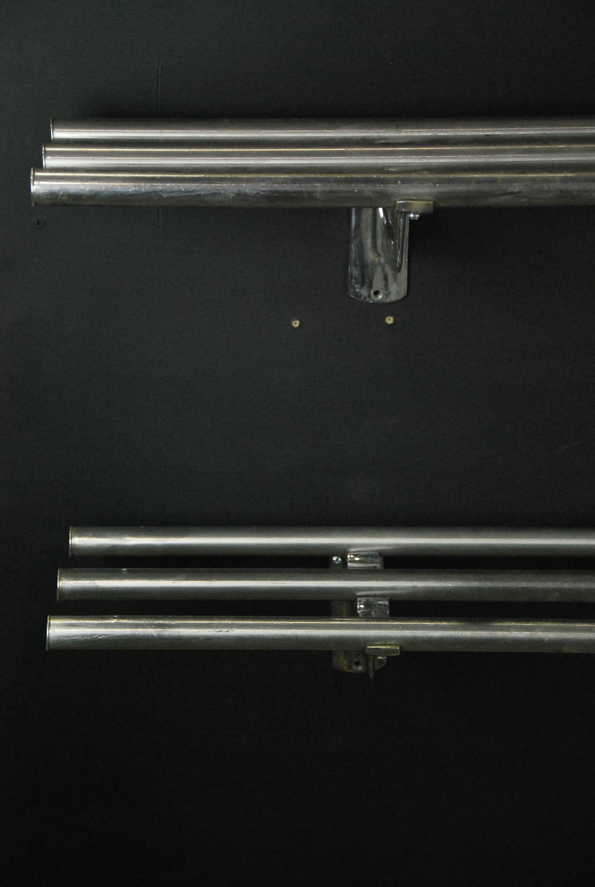 Two identical chrome-plated metal luggage racks with cast molded wall fitters.

Recently acquired from a collection in Canada.