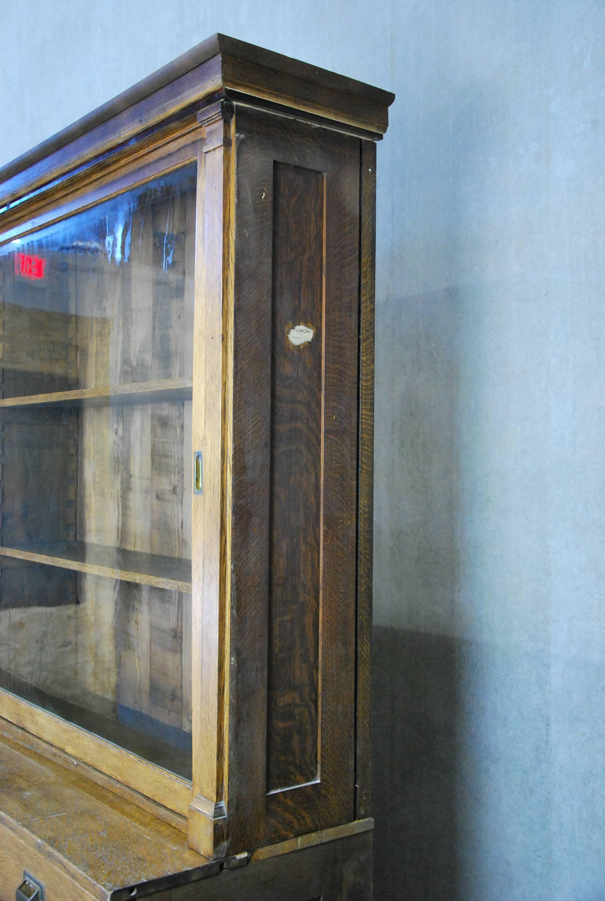 Oak cabinet found in Montreal, with multi drawers, sliding glass doors, adjustable shelving in two pieces.

This was once in a pharmacy in old Montreal.