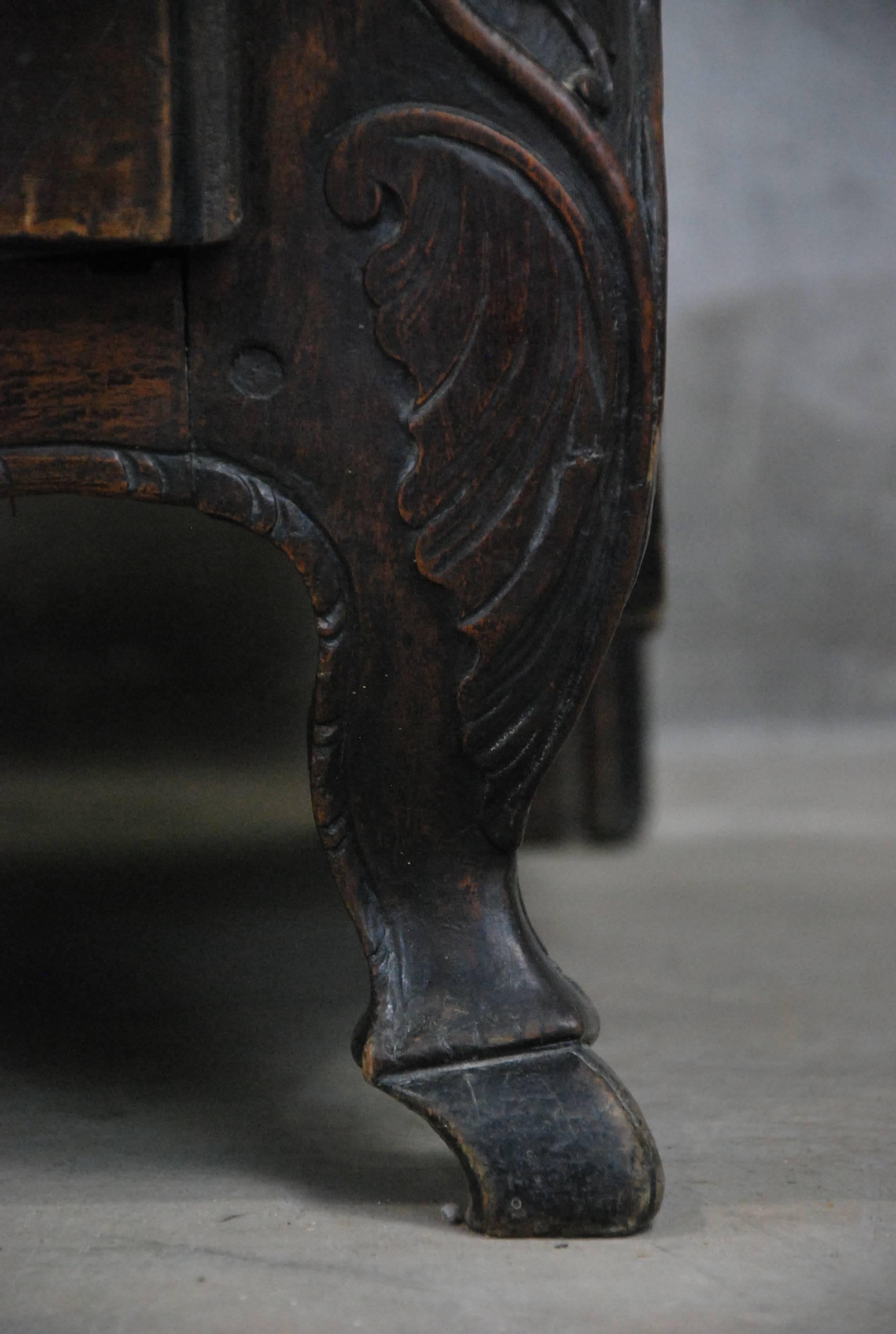 Classic French furniture from the early 1800s. A walnut commode has elegant hand-carved details. Acquired from a private collection, it was purchased in France in the 1960s. It appears to be in untouched condition with period brass hardware and