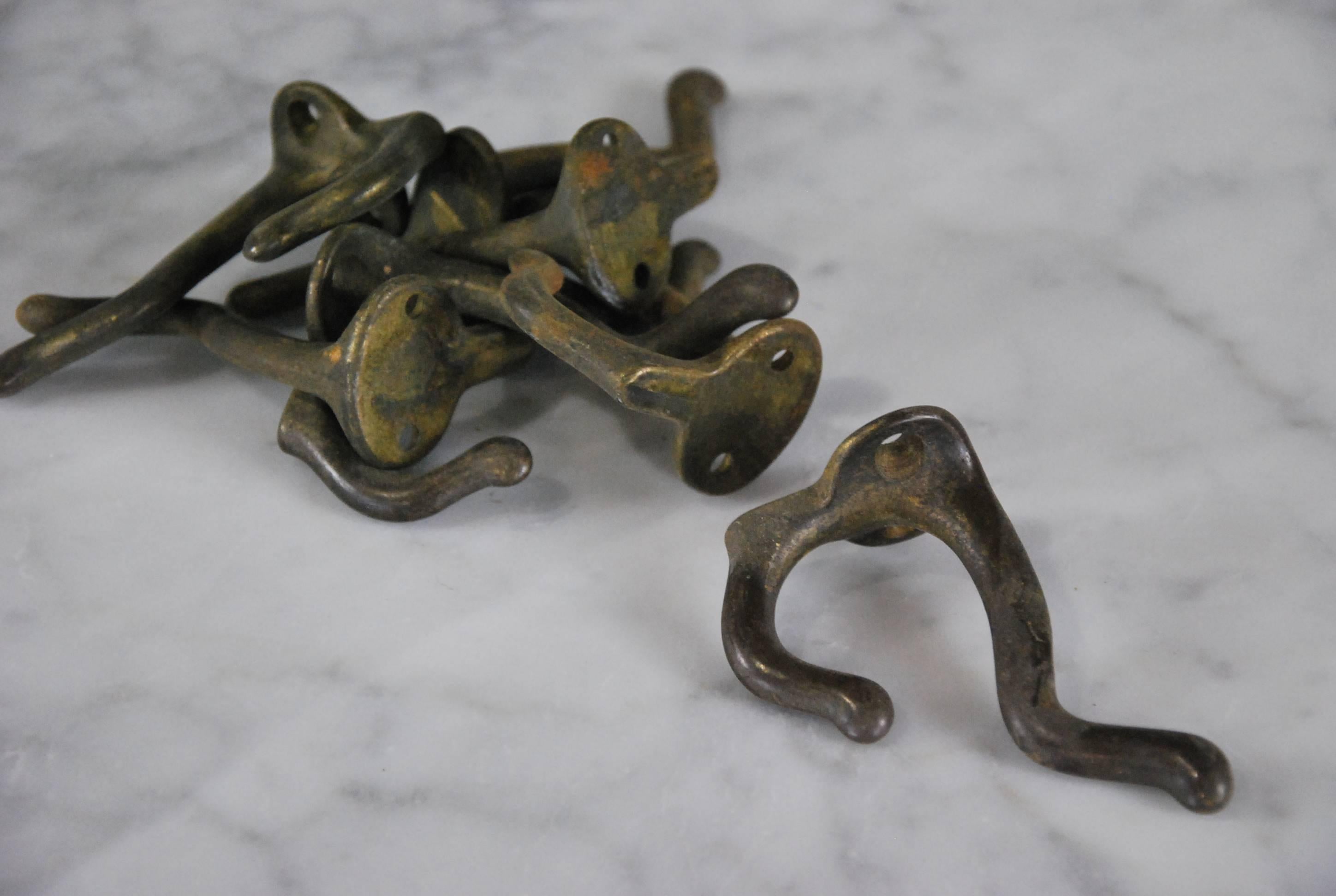 We have a quantity of 60 iron coat hooks with a very worn brass coating.
Salvaged from an old school in upper New York state.
