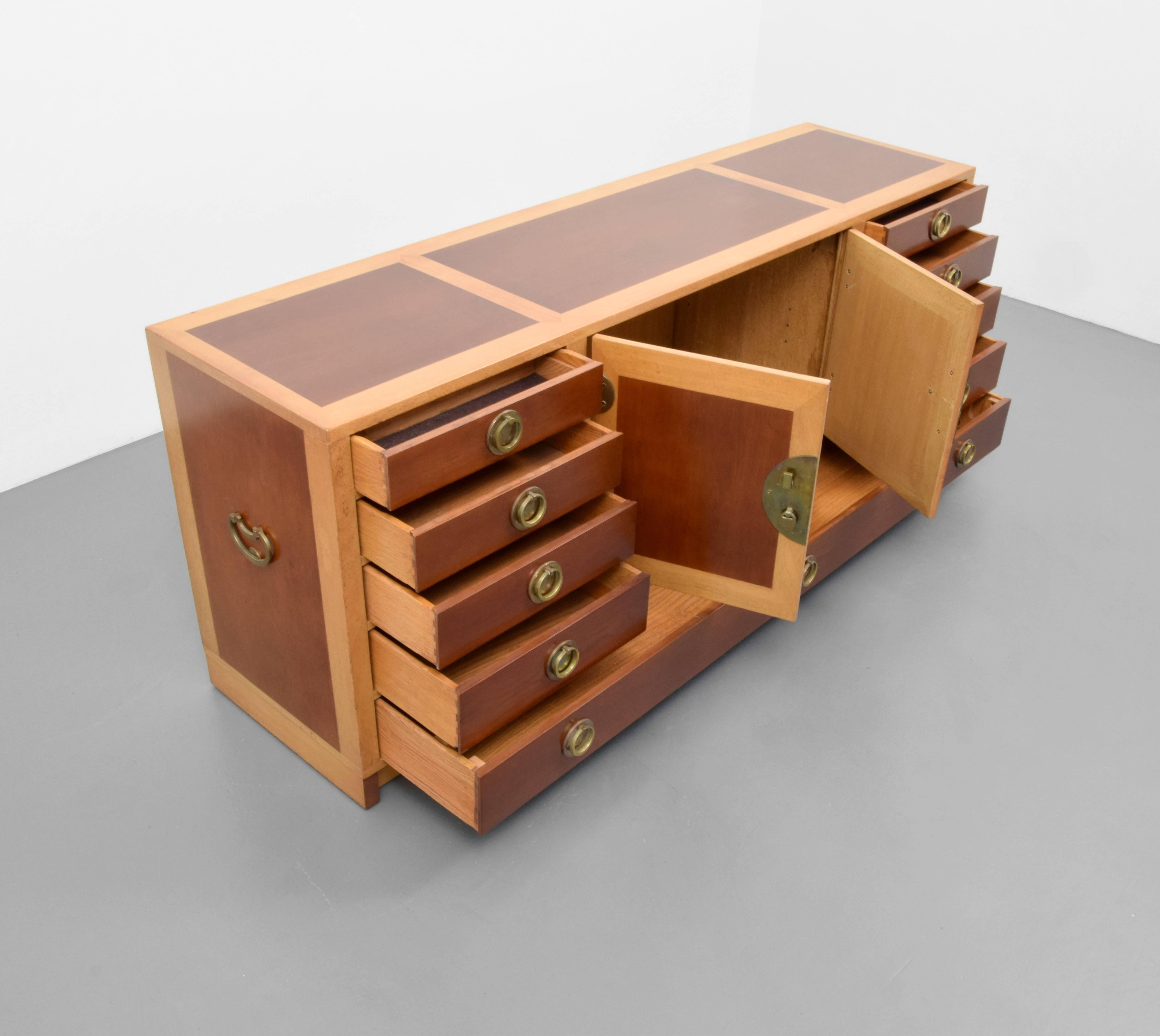 Cabinet/server/buffet features eight drawers: two drawers with separators, one drawer the length of the cabinet and two doors revealing storage and holes for an adjustable shelf.

Edward Wormley's furniture designs utilized quality materials and