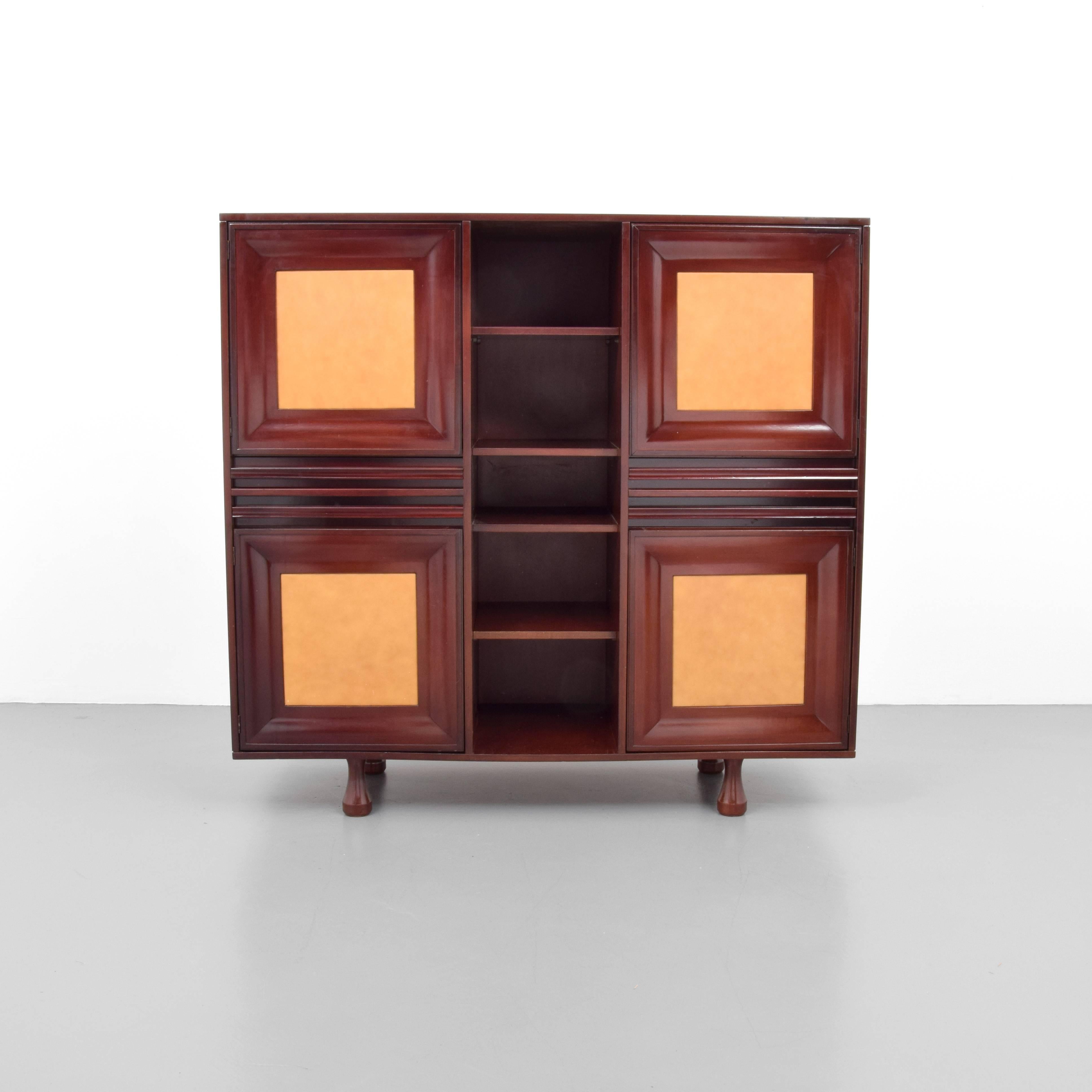 Cabinet features four drawers and four doors with storage and eight total shelves.
