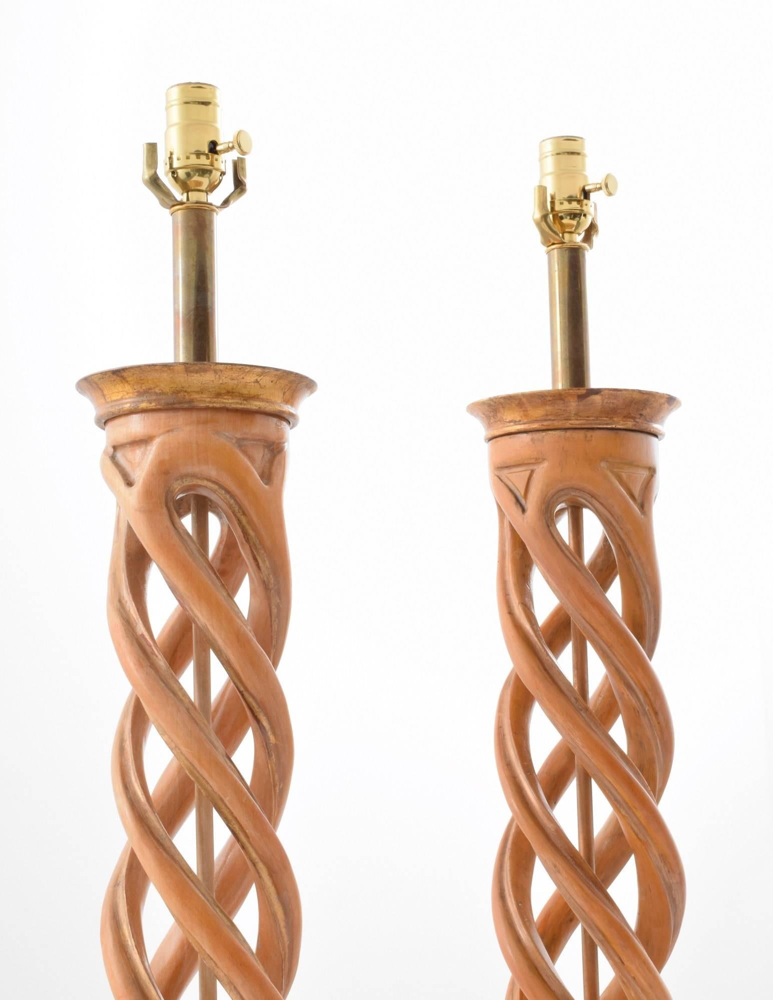 Pair of carved lamps with gold leaf wood bases and tops by Frederick Cooper Studios