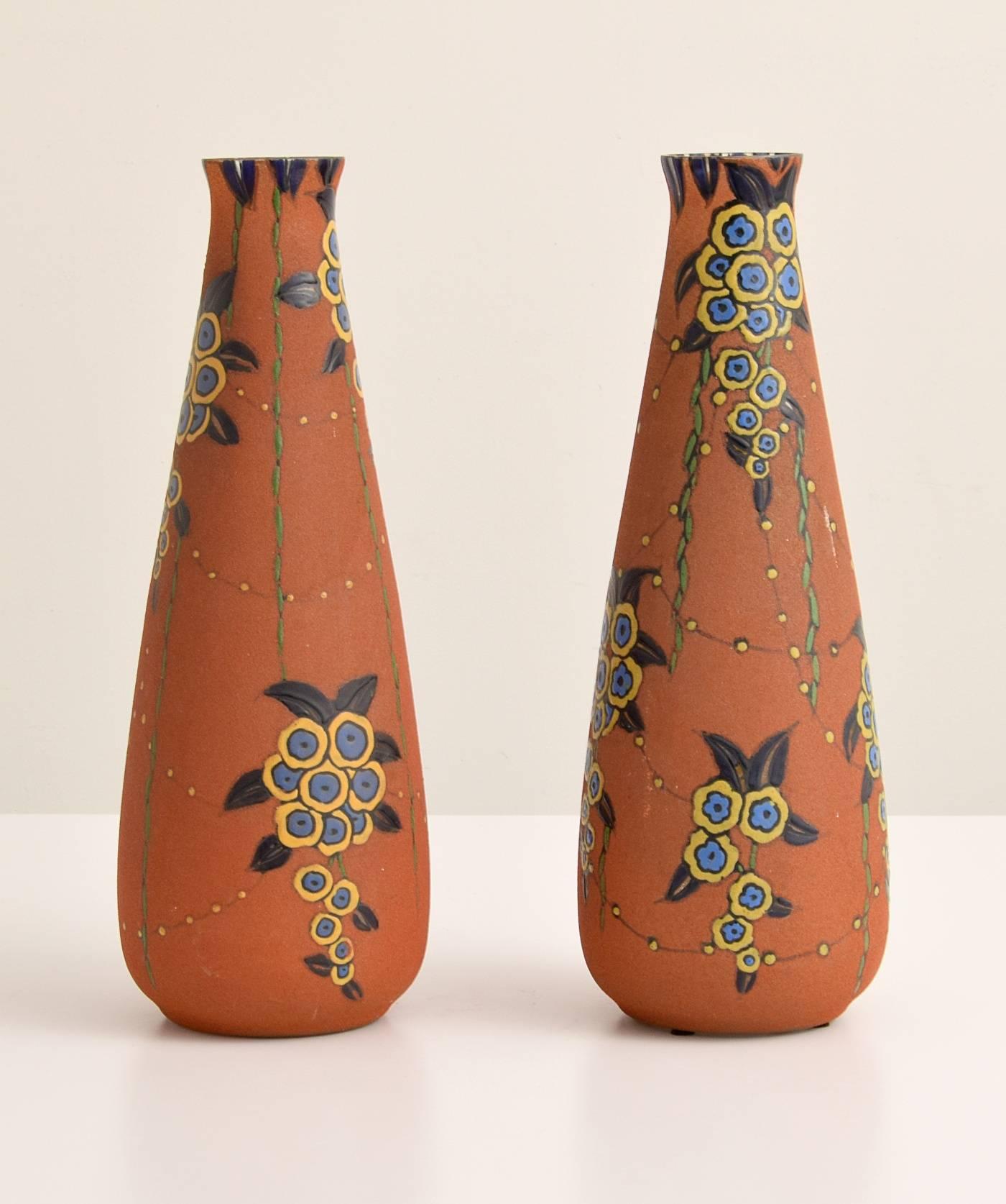 Pair of large Art Deco thickly enameled vases by Auguste Heiligeinsten (French, 1891-1976) for Société Anonyme des Etablissements Leune. The glass body was made by Daum. The pattern is Brindilles and the form is Sirene. 


.