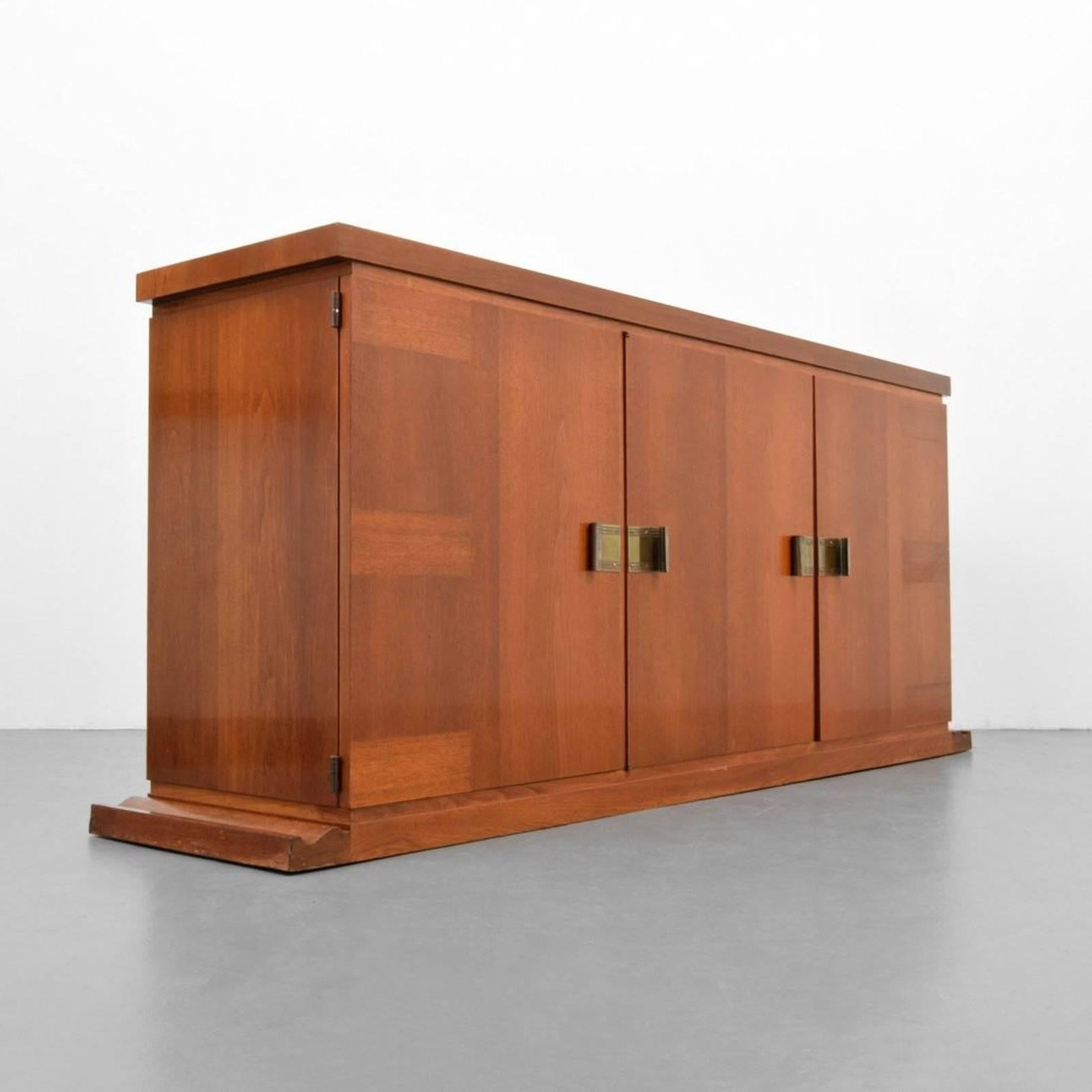 Cabinet has one door revealing four drawers, and a pair of doors revealing four larger drawers by Tommi Parzinger for Parzinger Originals. Cabinet was authenticated by Todd Merrill, noteworthy collector and dealer of 20th century modern and