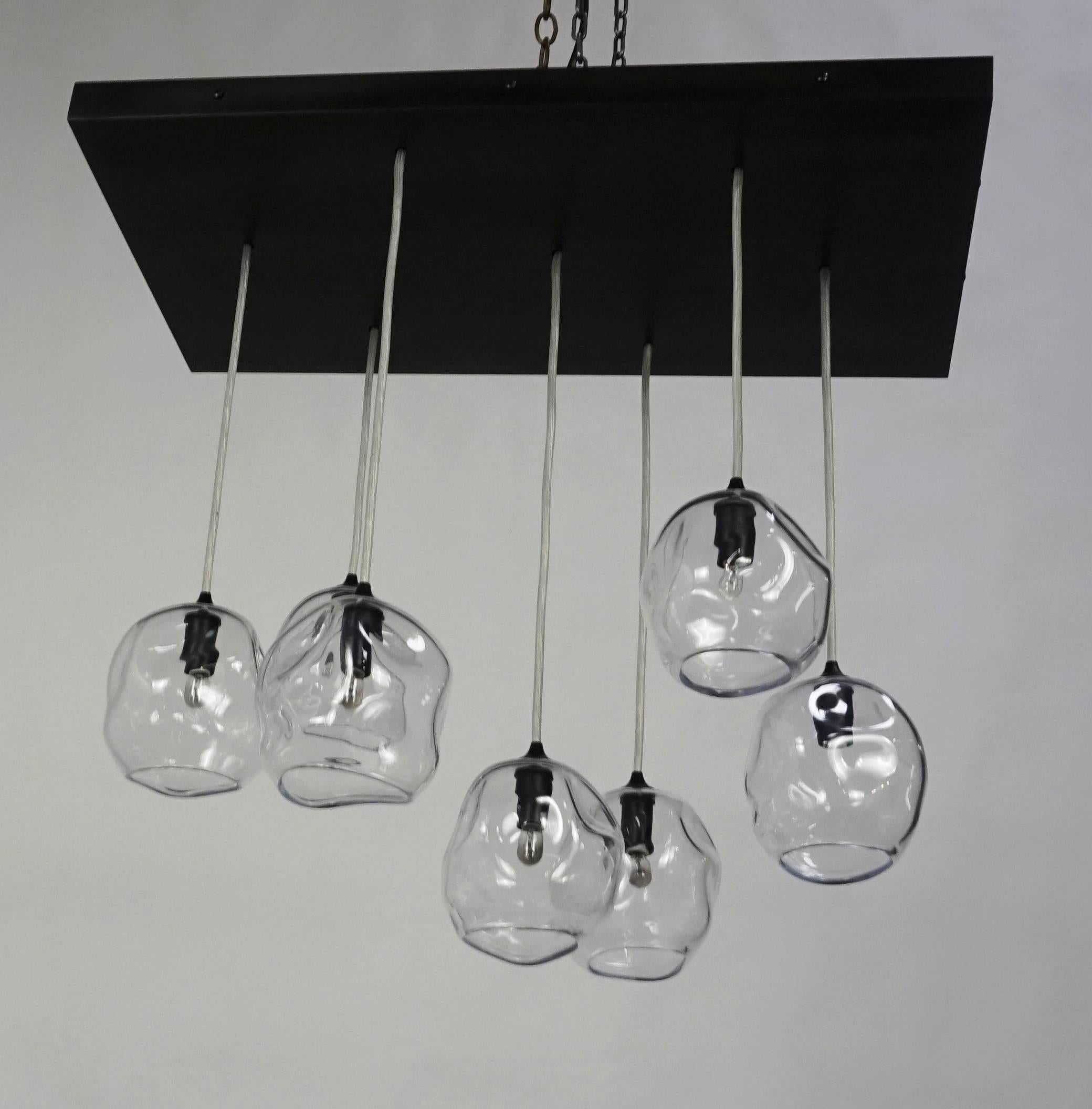 Custom infinity cluster pendant by John Pomp Studio.
Quantity: Seven (7) handblown sculptured glass pendants with custom metal canopy. Dimension of cluster arrangement to fall with range of 14” from top of pendant to finished ceiling to 27” at
