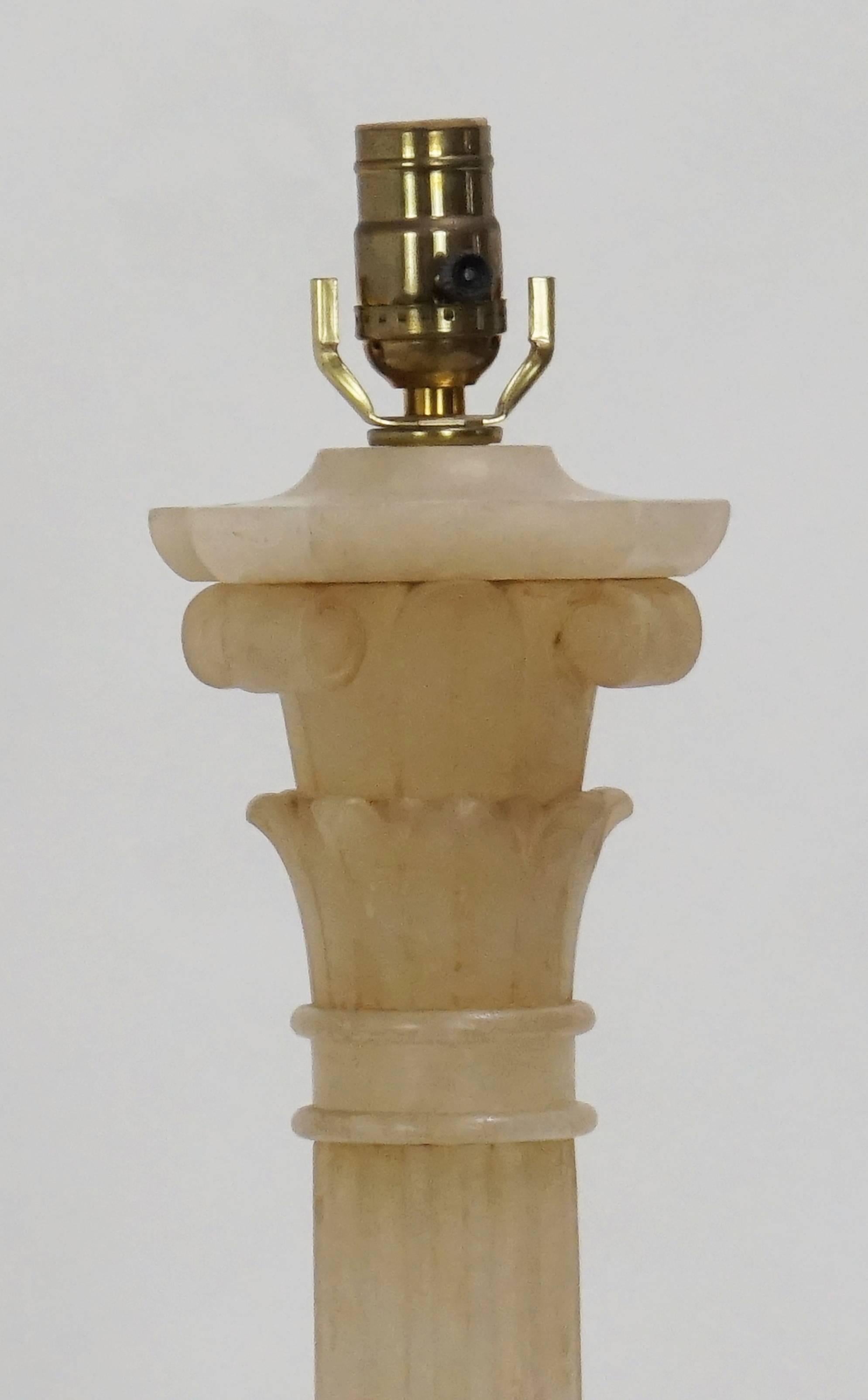 This alabaster column table lamp is made of a rare alabaster in a rose/rust color.  It has a refined, monumental look.  Great condition with variegation in color throughout.