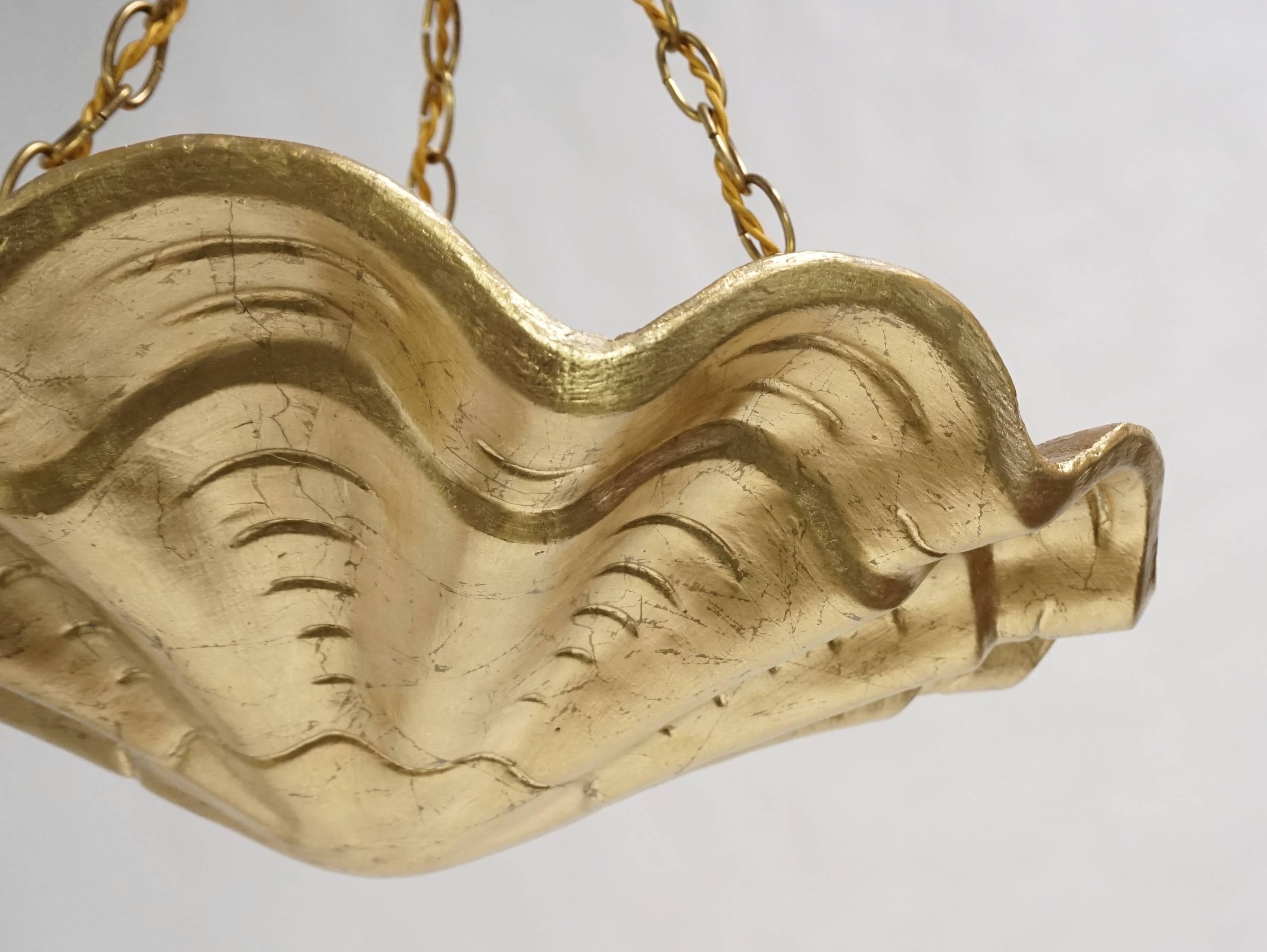 A new take on an old Classic. These plaster shell pendants have been gilded. They are one of the older shell pendants and there is horsehair in the plaster. Newly rewired, UL listing available for an additional fee. Two pendants available.