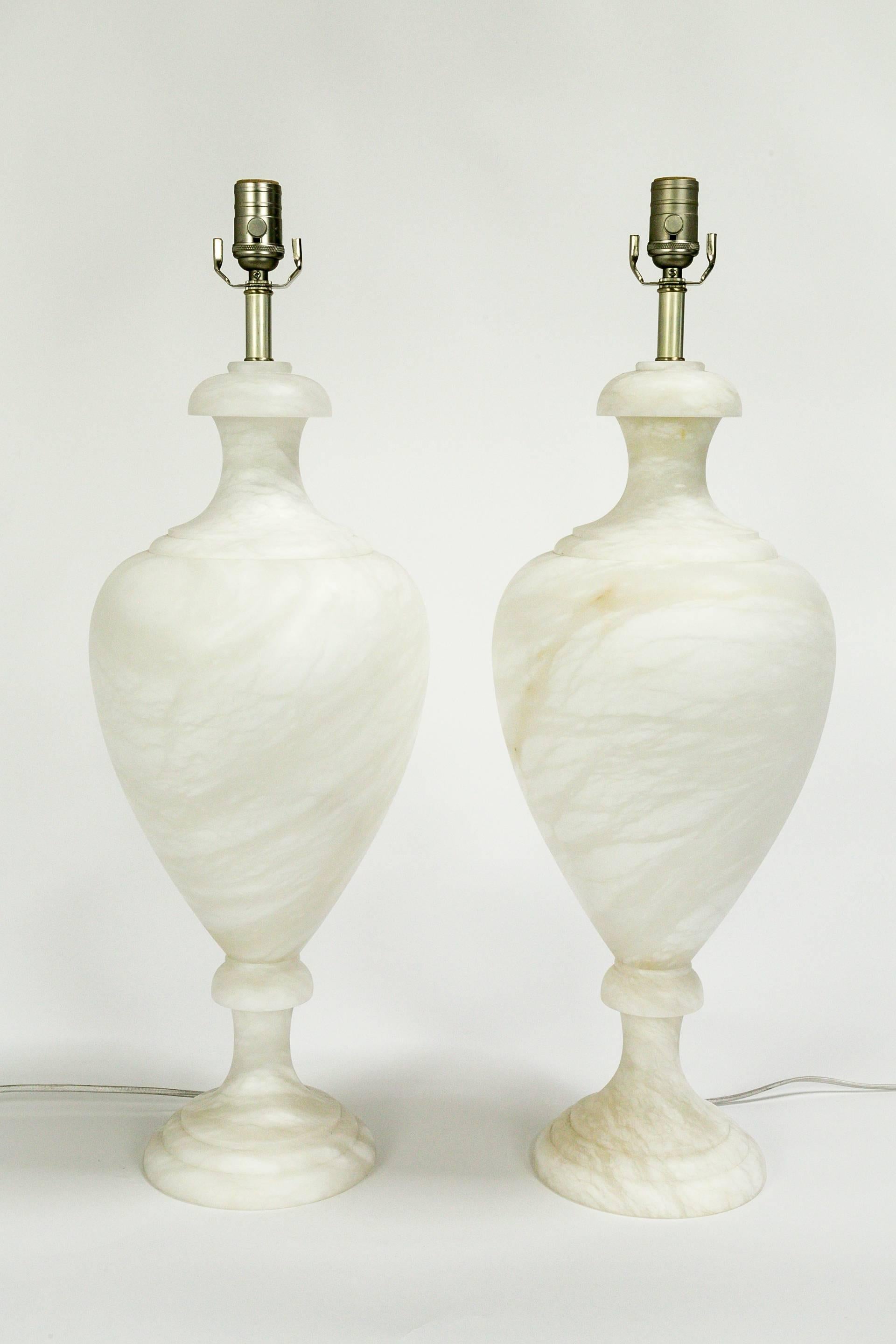 Monumentally sized, classical, covered Greek urn style lamp base in beautifully veined alabaster; unusually lit from within. The ivory color warms in tone when the inside light is turned on. Designed by Nelson Bloncourt of San Francisco. These made