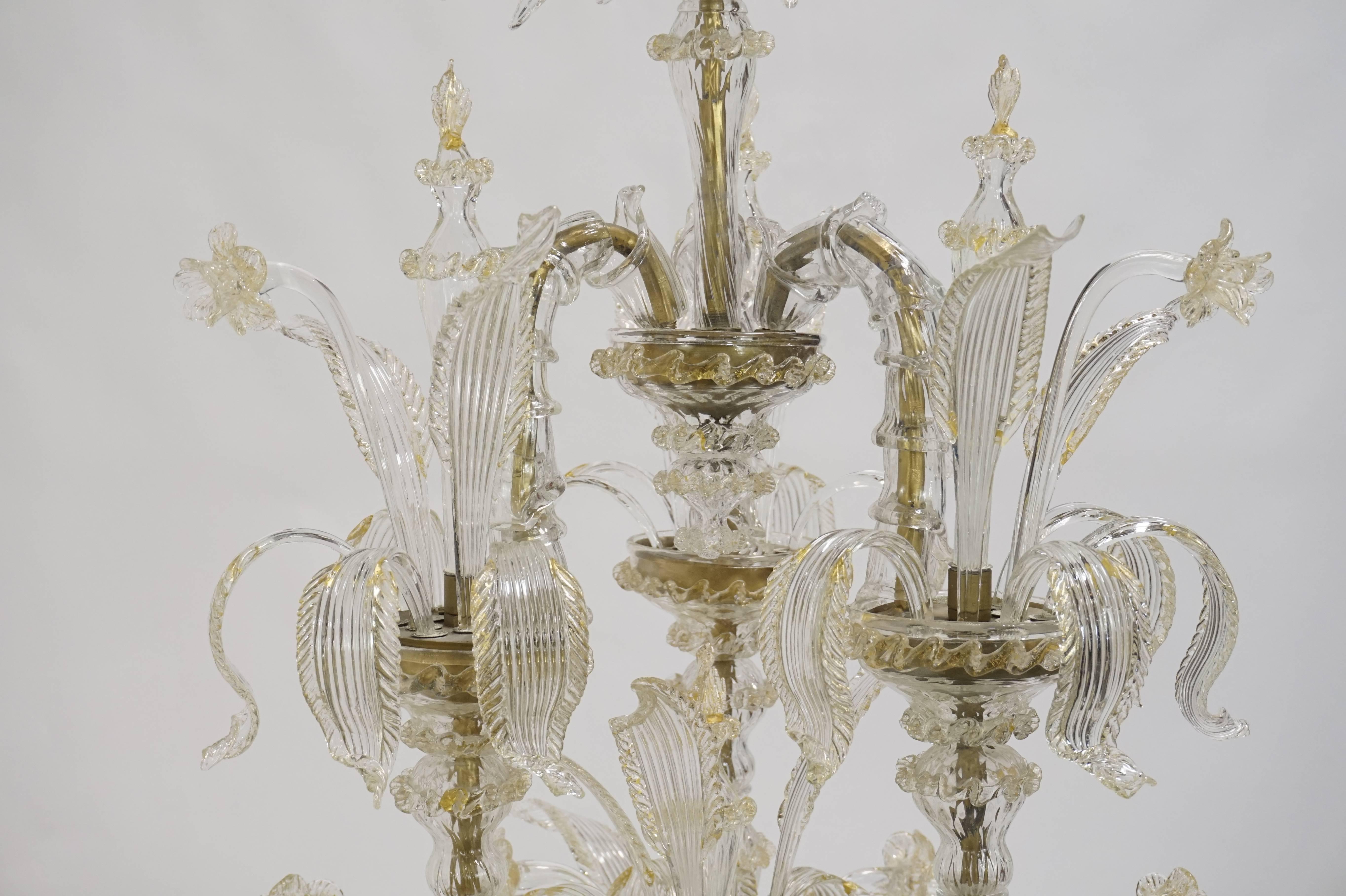 Elegant Murano Ca'Rezzonico chandelier composed of 12 arms with three fabulous uprights. Grand and lovely chandelier with gold crystal and brass accents.  1950.  Recently restored.  Incredible sale price.
