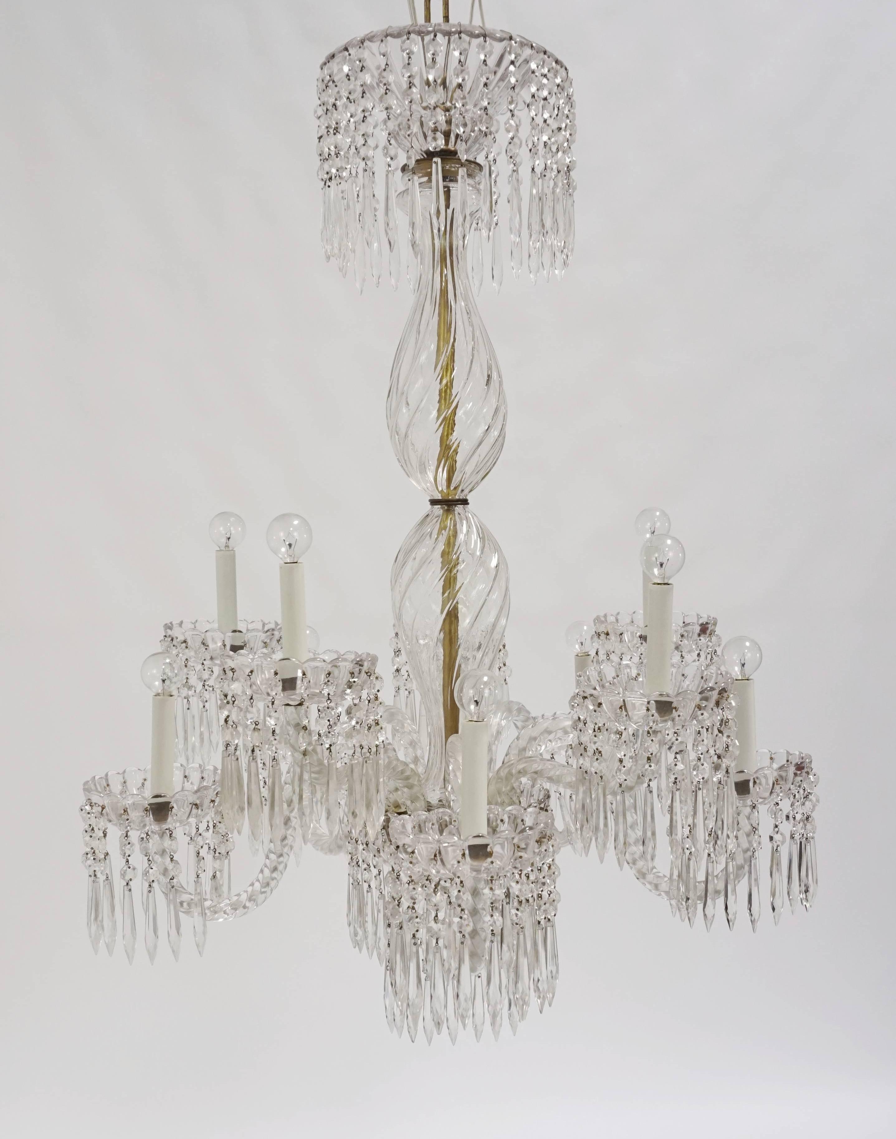 An exquisite, 1930's, French, 10-light chandelier; made of all glass and crystal undulating, rope arms, gadrooned bobeches, and column pieces; with and inner brass stem.  Octagon and spear crystals hang from the body dish and bobeches forming