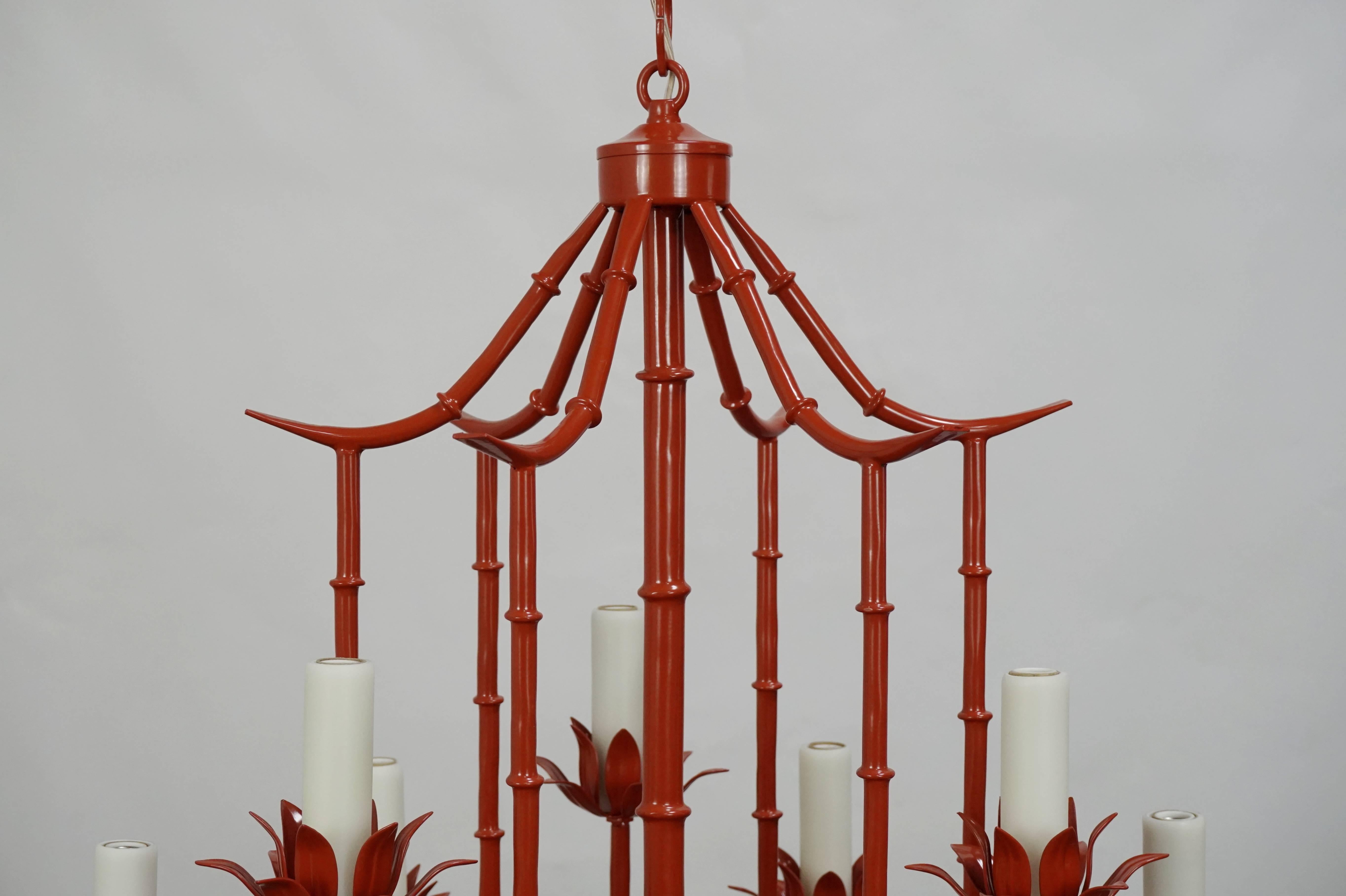 Nine light coral colored faux bamboo pagoda chandelier. Newly rewired and refinished, this vintage chandelier has a fresh Classic look. Smooth ivory resin candle covers will allow for a high wattage without ware.
UL listing available for an