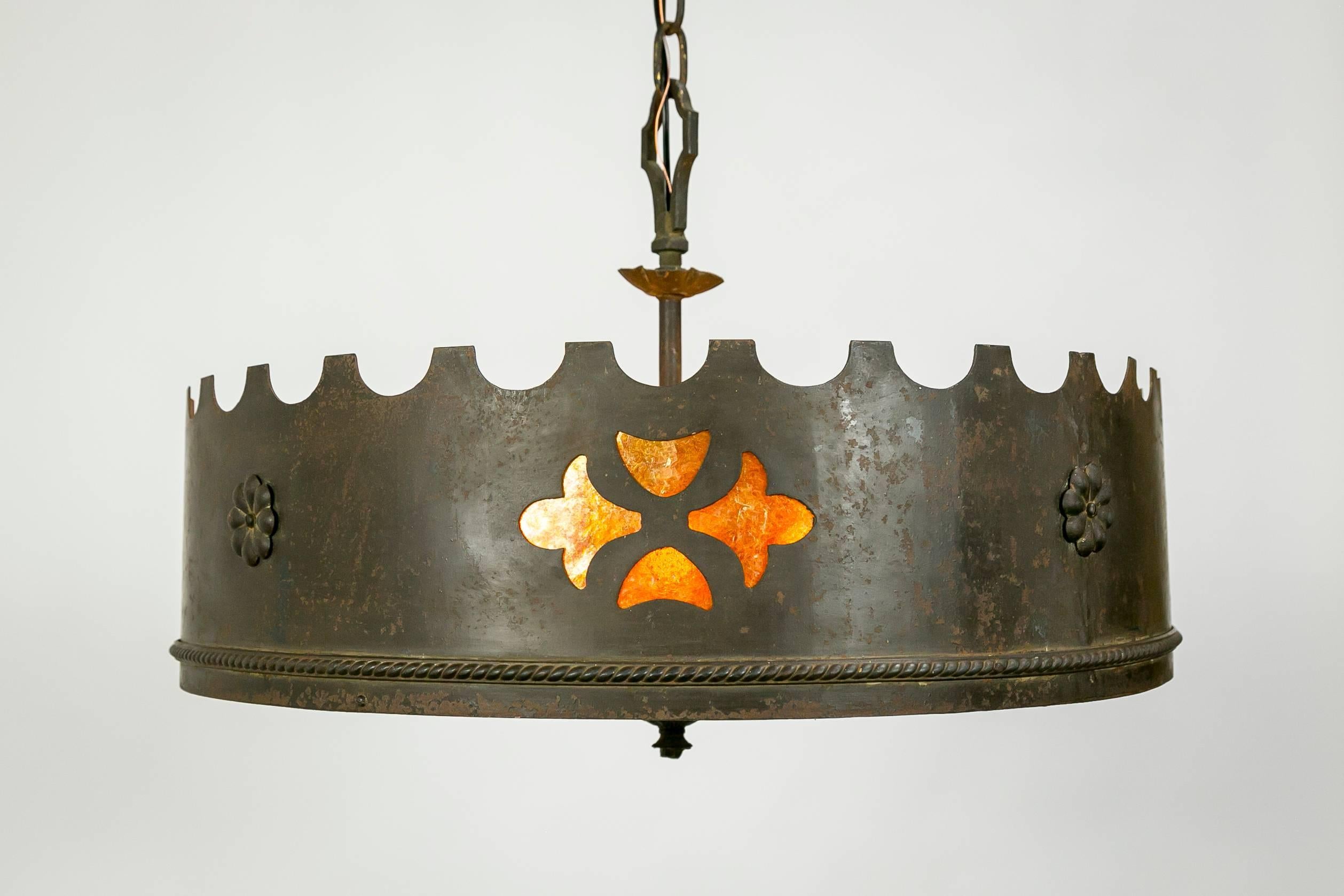This American, Medieval Revival chandelier is made of forged iron and gorgeous mica, with decorative iron chain and 6 sockets.  Fabricated between 1910-1930, this piece is most likely from Beverly Hills, where this style was the most popular.  This