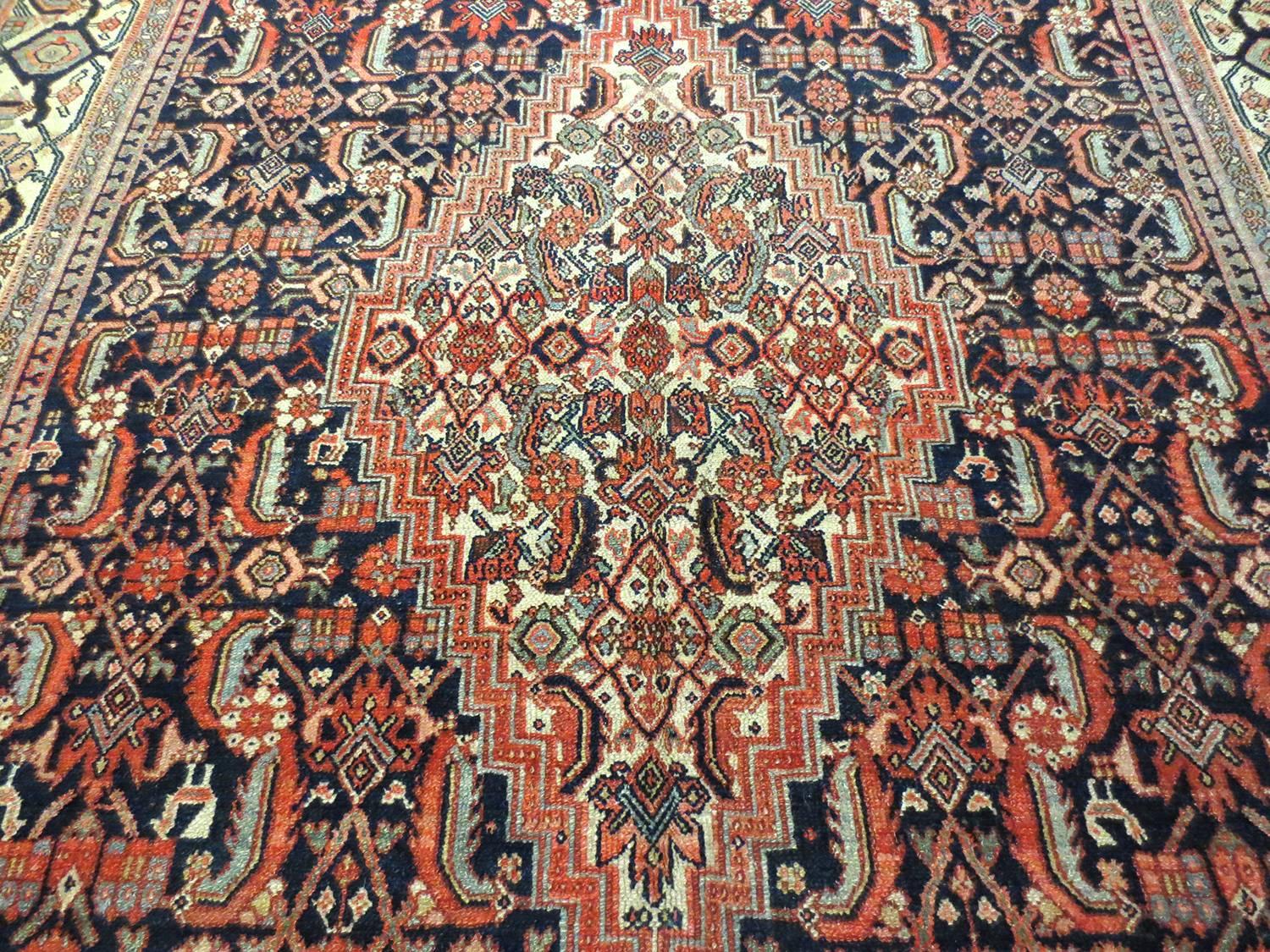 This is an antique Karabagh gallery size runner, circa 1890s. It is a beautifully woven, lavish rug with exceptional composition. An exquisite red diamond medallion sits at the centre of a deep navy blue field with four ivory corners in a color