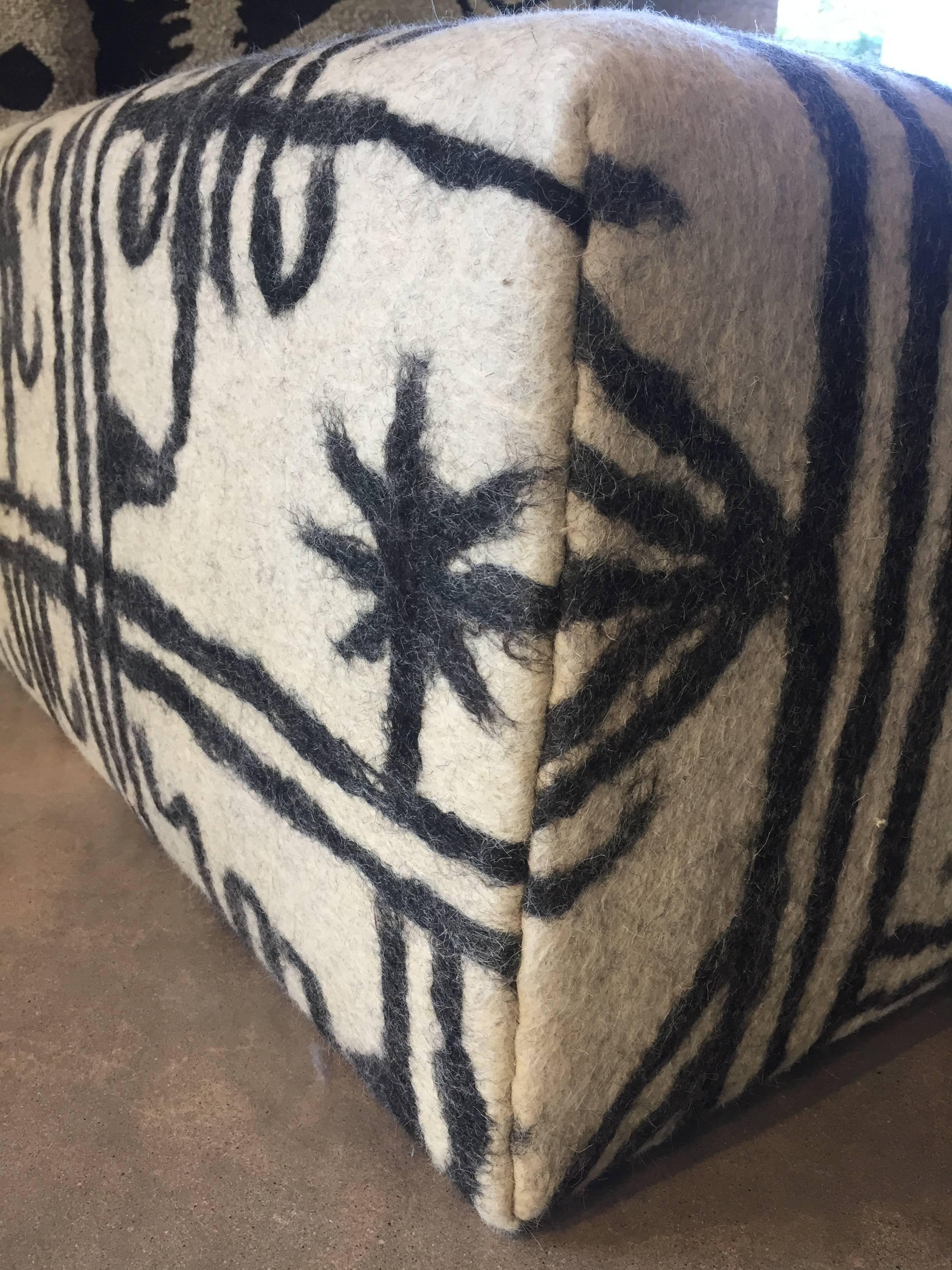 Handmade Afghan Felt with Congolese pattern made with 100% wool was used to make this beautiful ottoman. This ottoman is made in LA using this beautiful felt rug giving it a nice simple ethnic look.