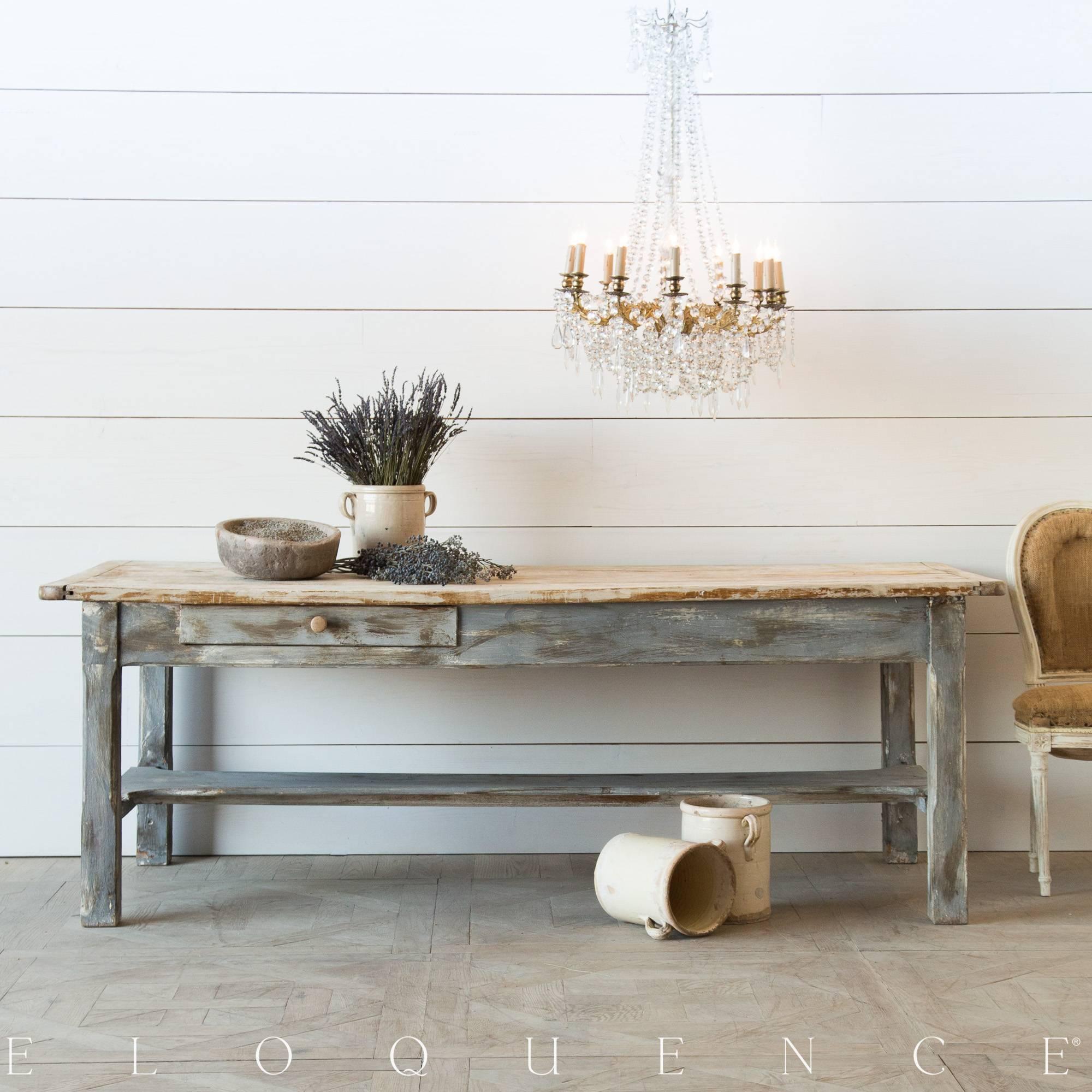 Gorgeous antique farmhouse kitchen table. This sturdy table, built using solid planks features two drawers; one on either side of the piece. The dark grey and earthy hues of the apron and legs beautifully contrast the natural wood top. The surface