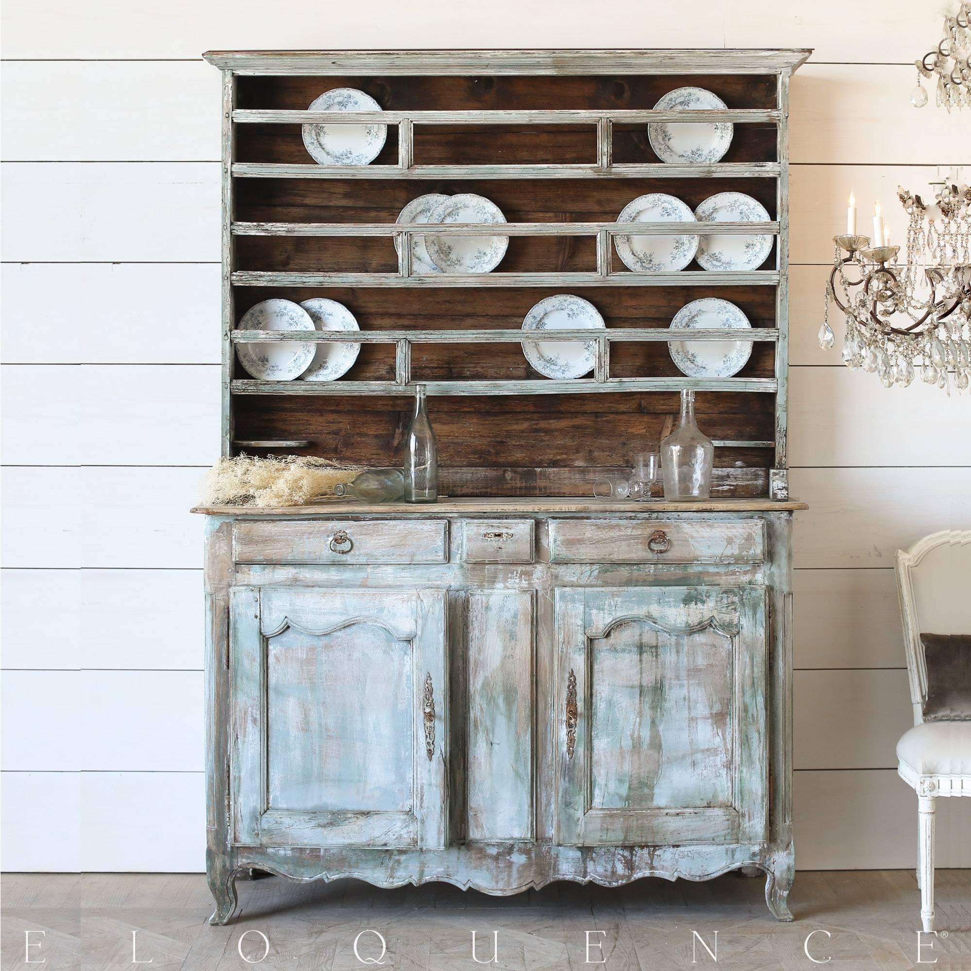 Striking antique cabinetin white washed turquoise, rubbed back to natural wood. The two pieces making up this statement sideboard are a perfect blend of beauty and functionality. Offering plenty of storage and display, the unique carvings and