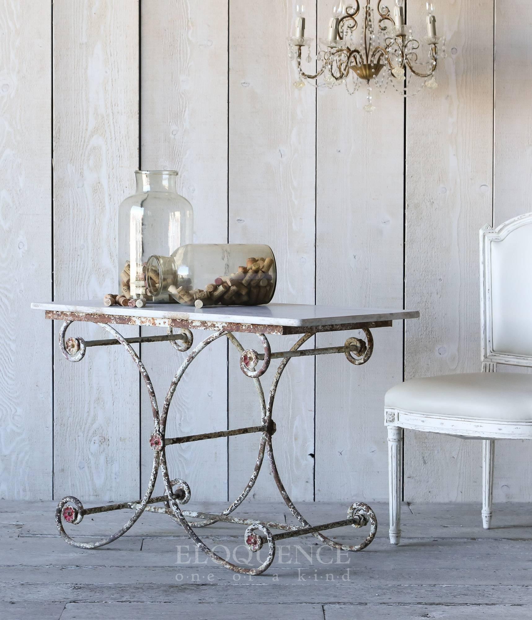 Darling antique scrolling Iron base table. Lovely original marble full of age and patina. Perfectly chipped off-white base, revealing rich rustic iron.