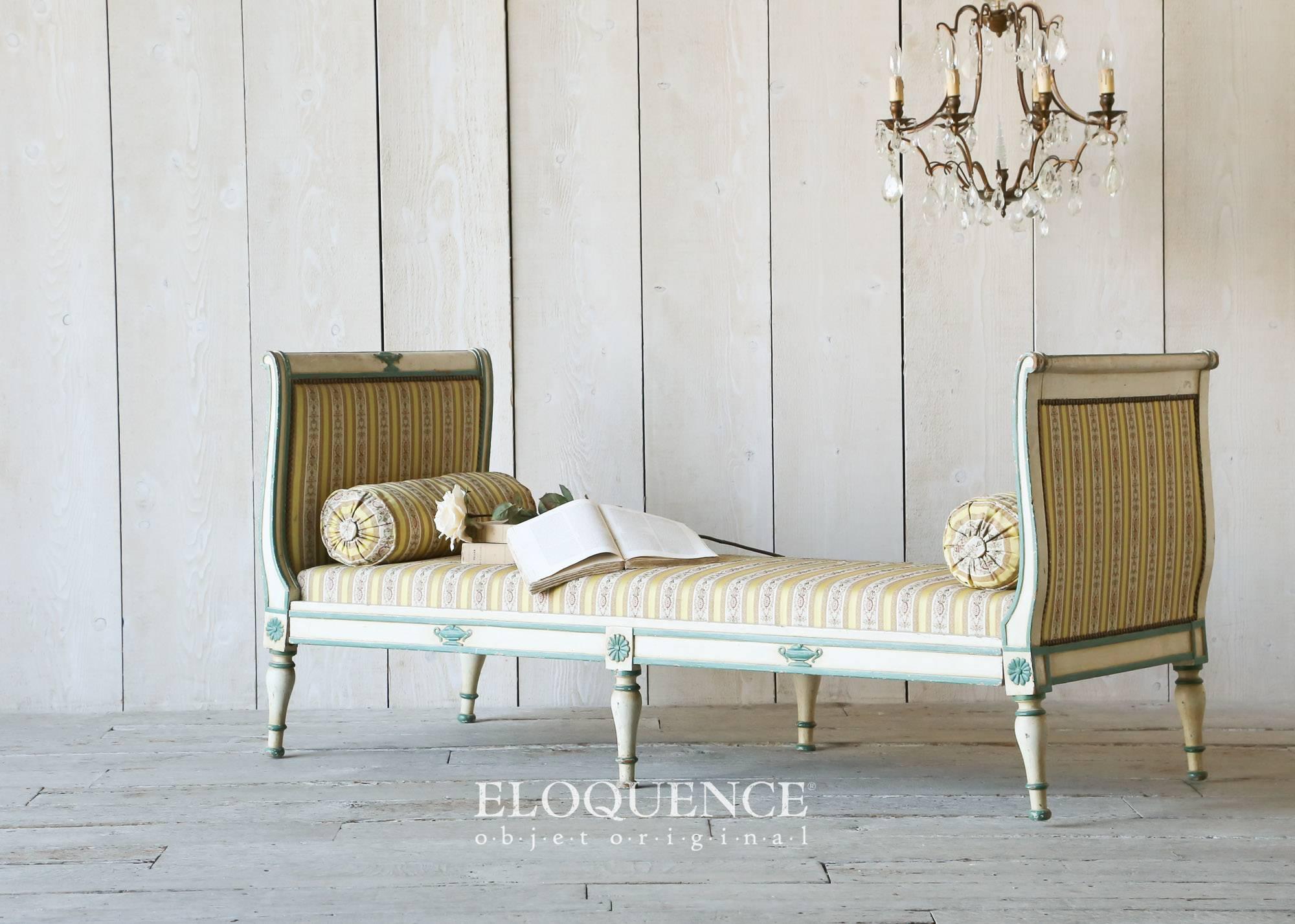 Lovely antique Empire style daybed finished in pale cream with vibrant teal highlights. Upholstered in striped satin damask in shades of gold, yellow, olive, pale pink, and rose. This is a petite bed with plenty of charm!
