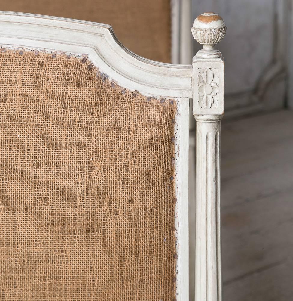 Darling antique twin sized bed in a deep aged duck egg finish. Burlap upholstery and round, carved finials add an air of whimsy to this piece.