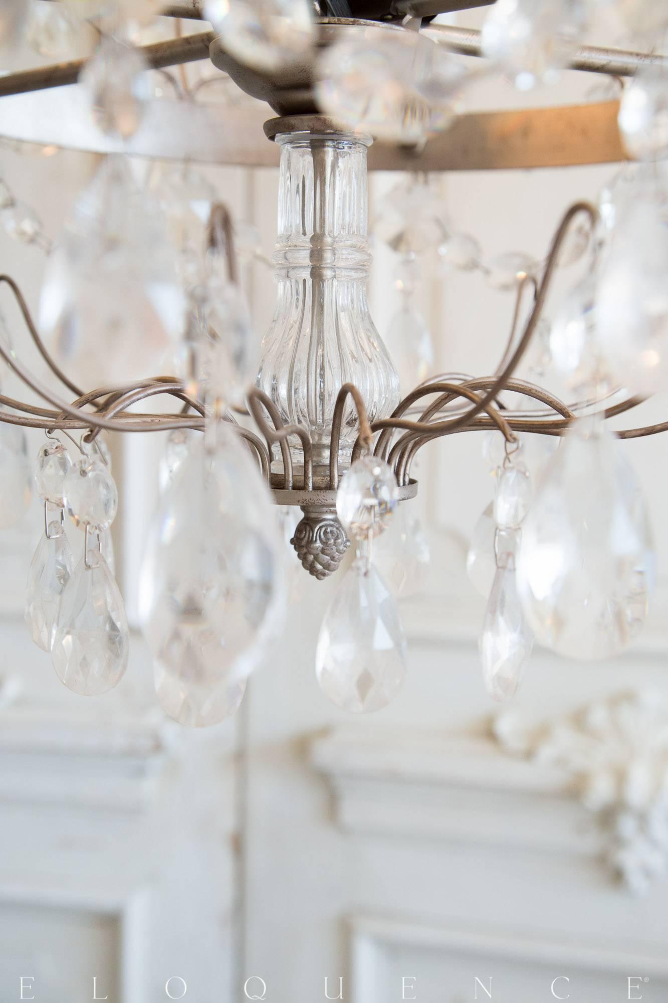 The Albertina® chandelier is a modern replica of a period Swedish antique. Named for Princess Sophia Albertina, this piece shines with royal elegance. The centre column prism and the glass crystal clusters are surrounded by ornate chains that lead