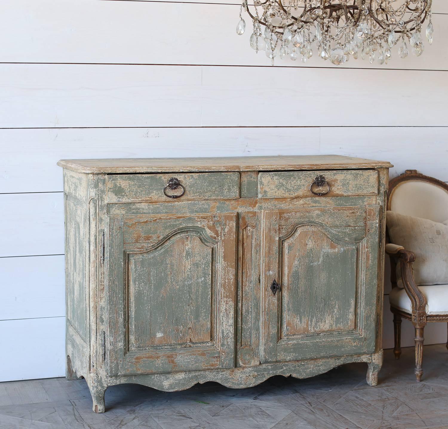 Rustic sideboard made of Old Pine and washed in a worn green finish. Two top drawers and cabinets provide ample storage along with the antique hardware and working lock for a unique touch.
 