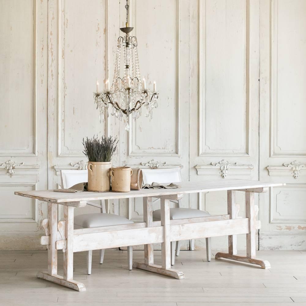 Beautiful antique dining table in pine circa 1910. The table is painted in a white finish distressed back to raw pine throughout. The country farmhouse style table with clean lines comfortably seats 6. Alternatively, the table is narrow enough to be