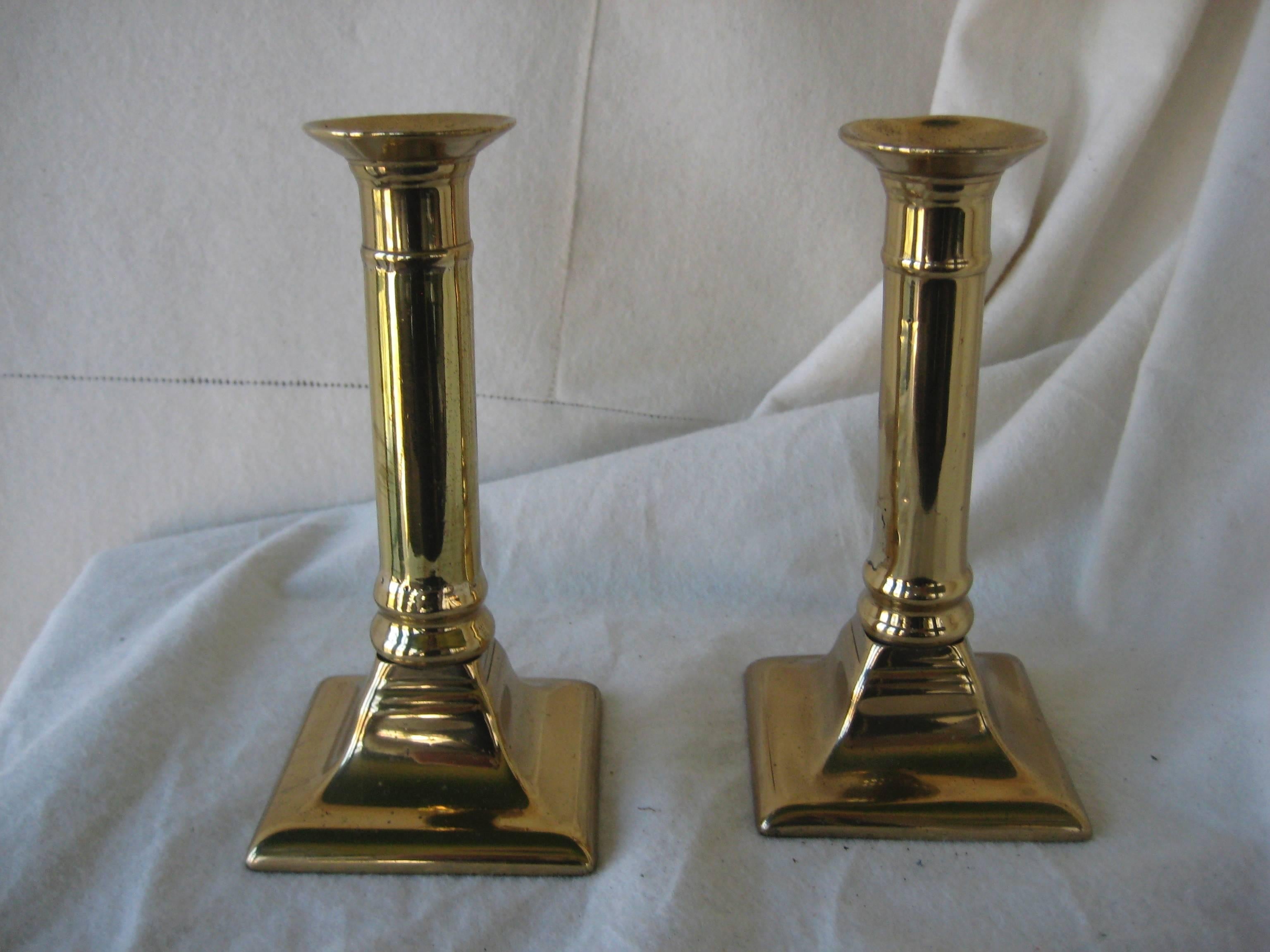 Pair of 19th century brass push up candlesticks with square base.