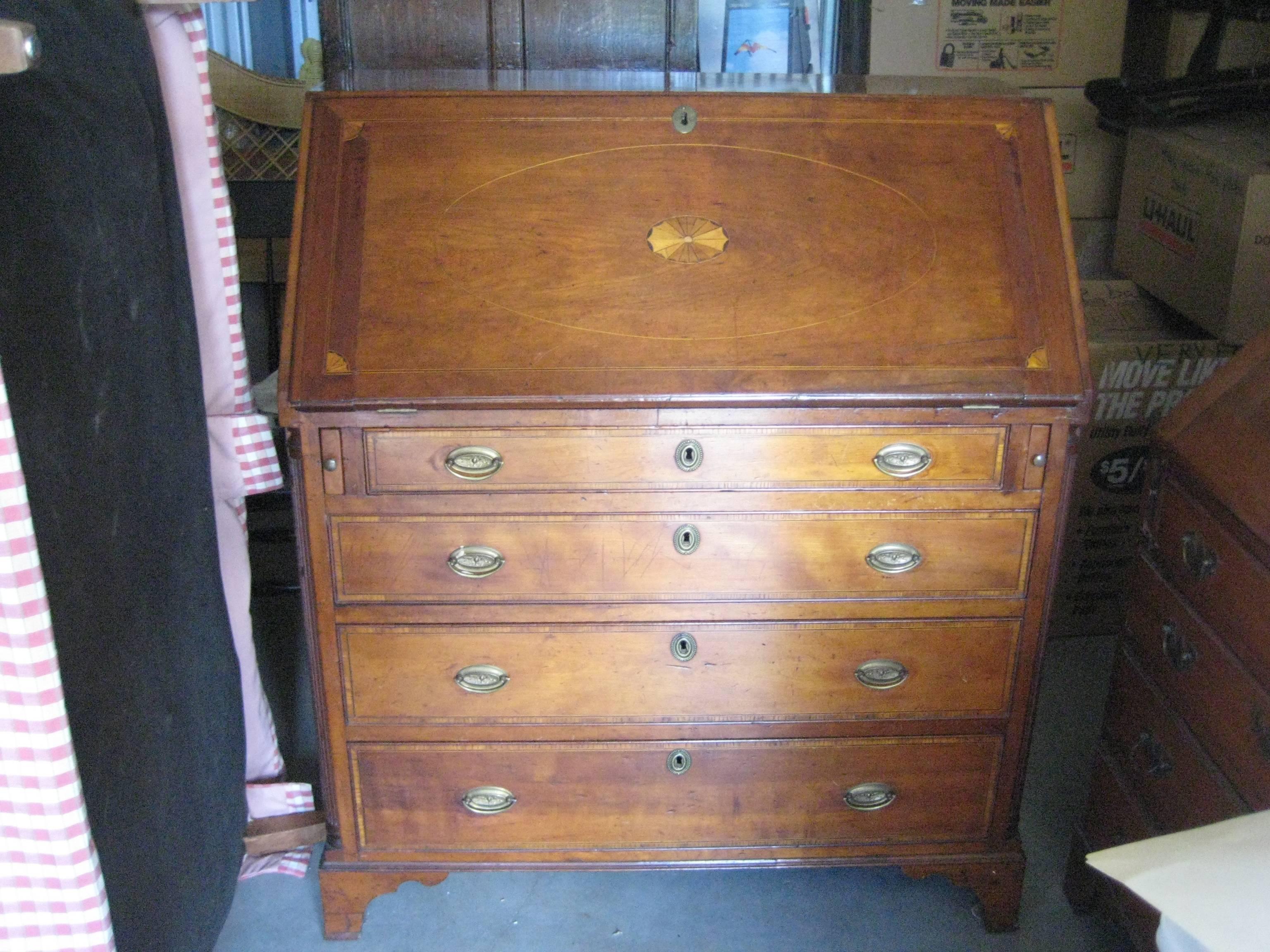 English fruitwood slant-top desk with inlaid design and details on the drawers.