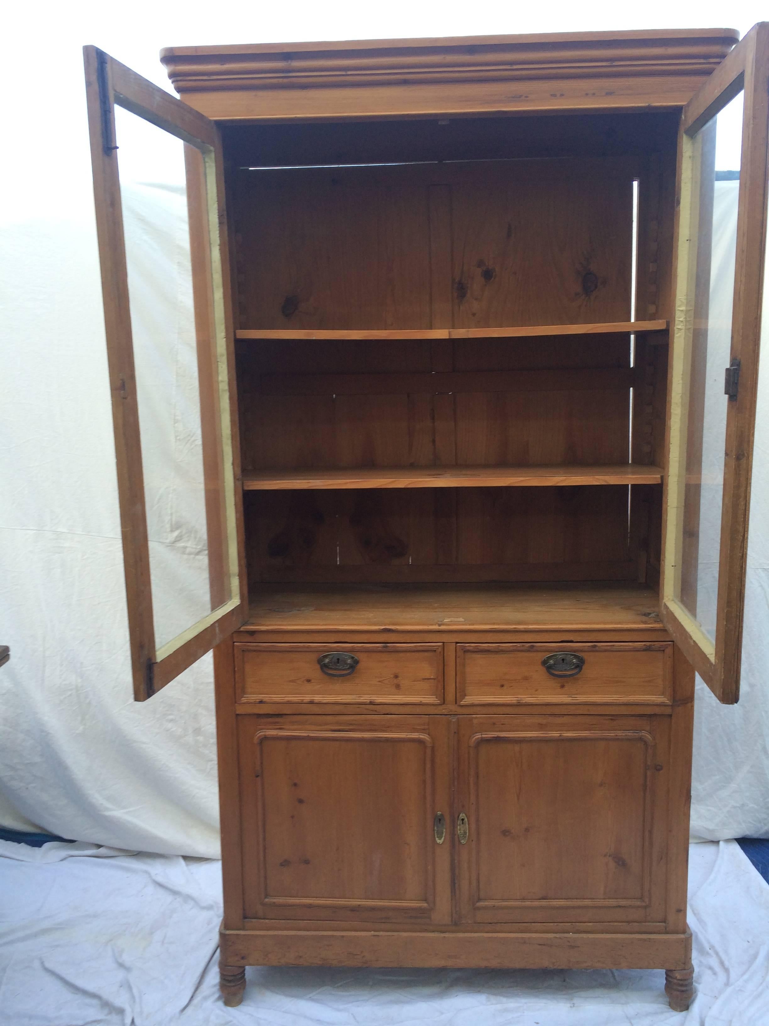 English pine cabinet with glass doors.