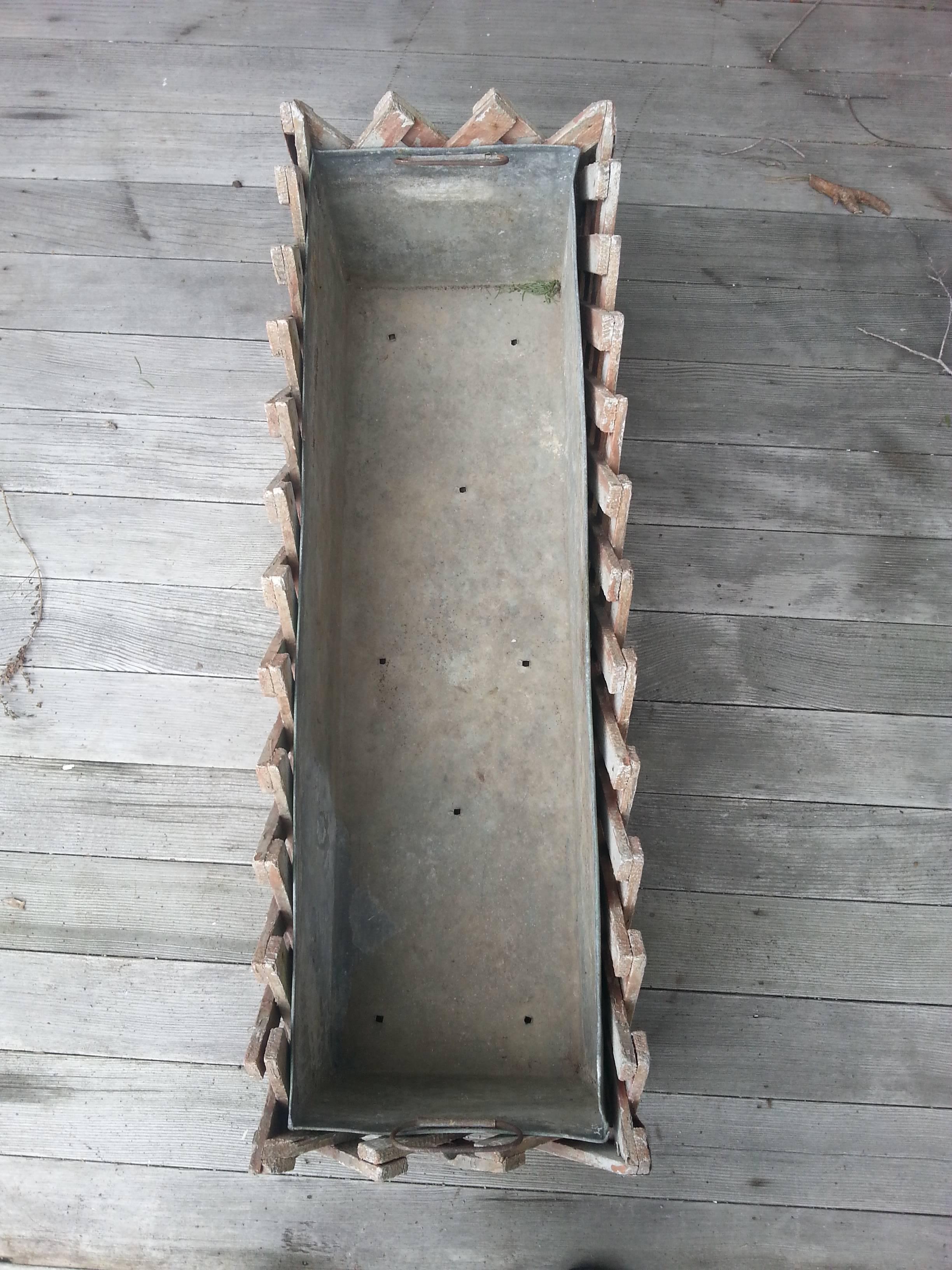 Lattice planter box. Wood lattice exterior, lead pan insert with drainage holes, side handles.  