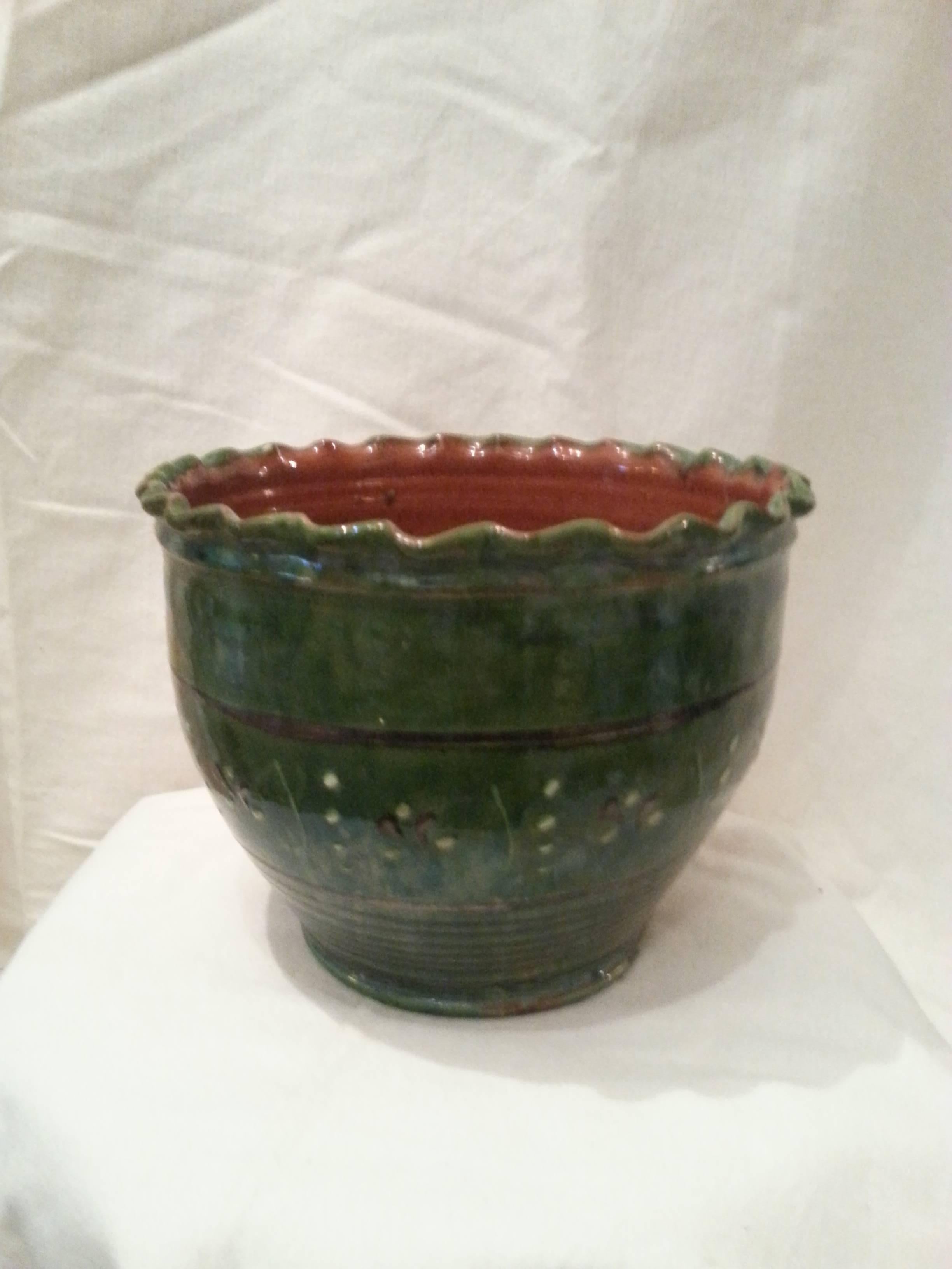 Green glazed Jardiniere. Scallop edge top. Small painted motif around. No drainage holes.
