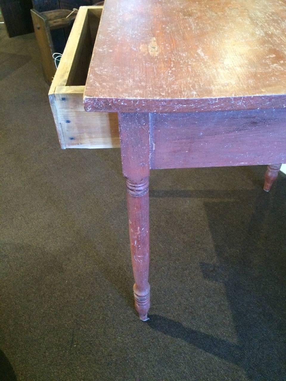 Antique side table in red paint finish.