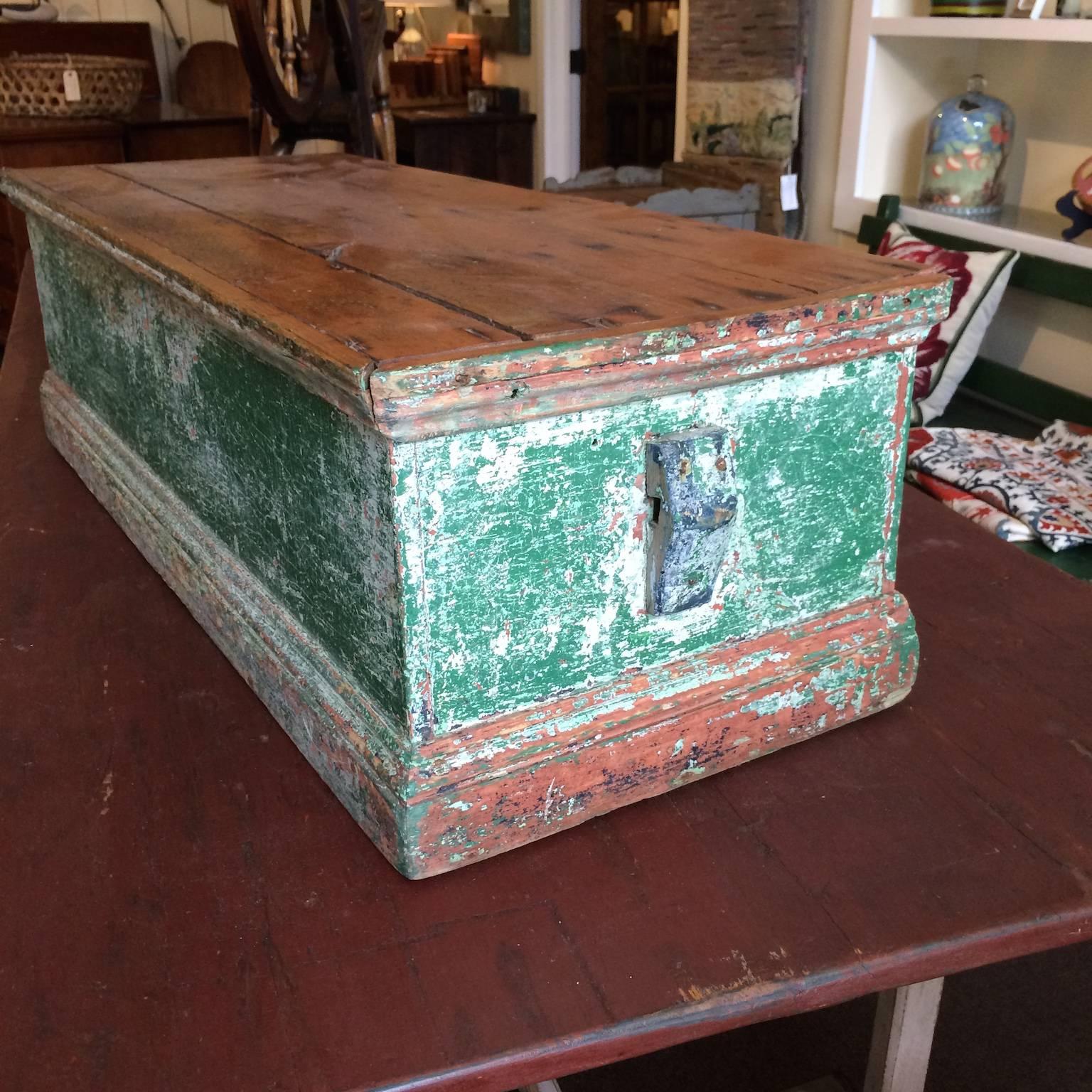 Sea chest in green paint with natural wood top.