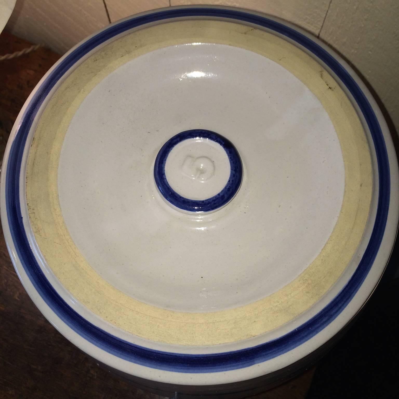 Five gallon stoneware jug with spout.  Decorative bands and 5 gallon designation in cobalt blue.  Spout is nonoperational.