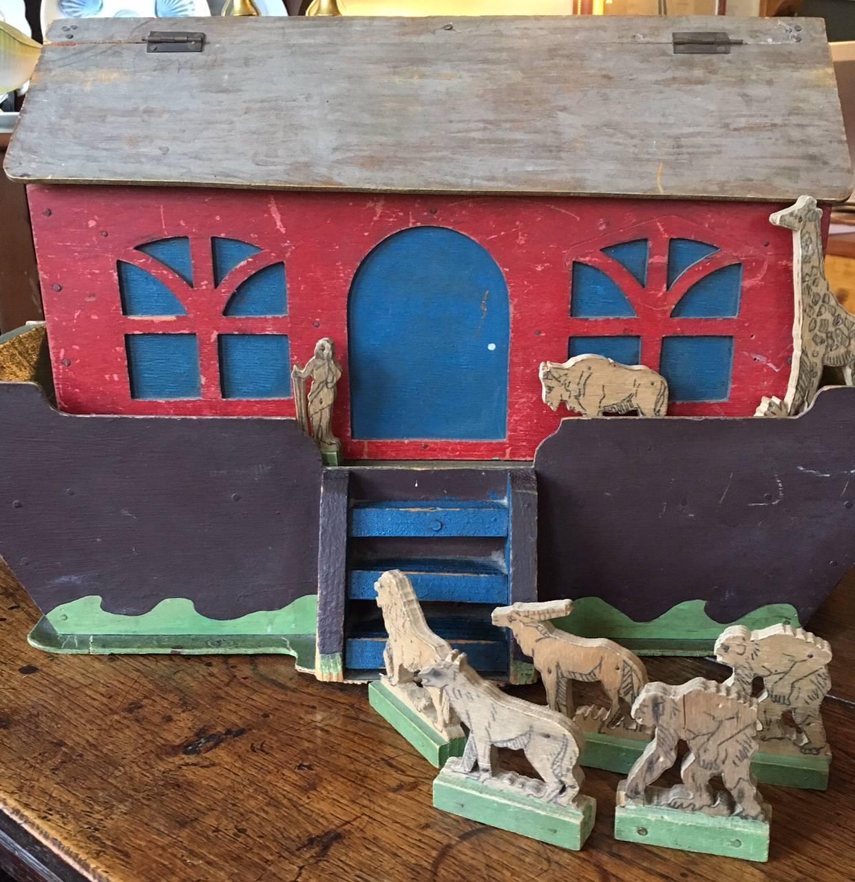 19th century handcrafted Folk Art Noah's Ark, circa 1890s with a variety of wooden figures, comprising 13 animals and Noah. Some pairs of animals, some singles. Roof of Ark is hinged for ease of storage. Old label inside indicates that this was hand