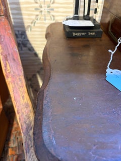 Decoratively carved trestle base sewing table
