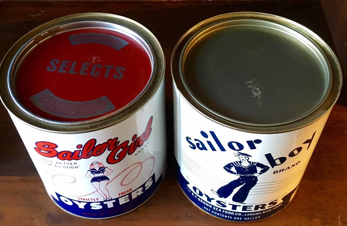 Vintage sailor girl and sailor boy 1 gallon oysters tins. Sailor girl oyster tin held Maryland oysters packed for a Chicago label, circa 1970. Sailor boy oyster tin also packed for a Michigan label, circa 1970.
 