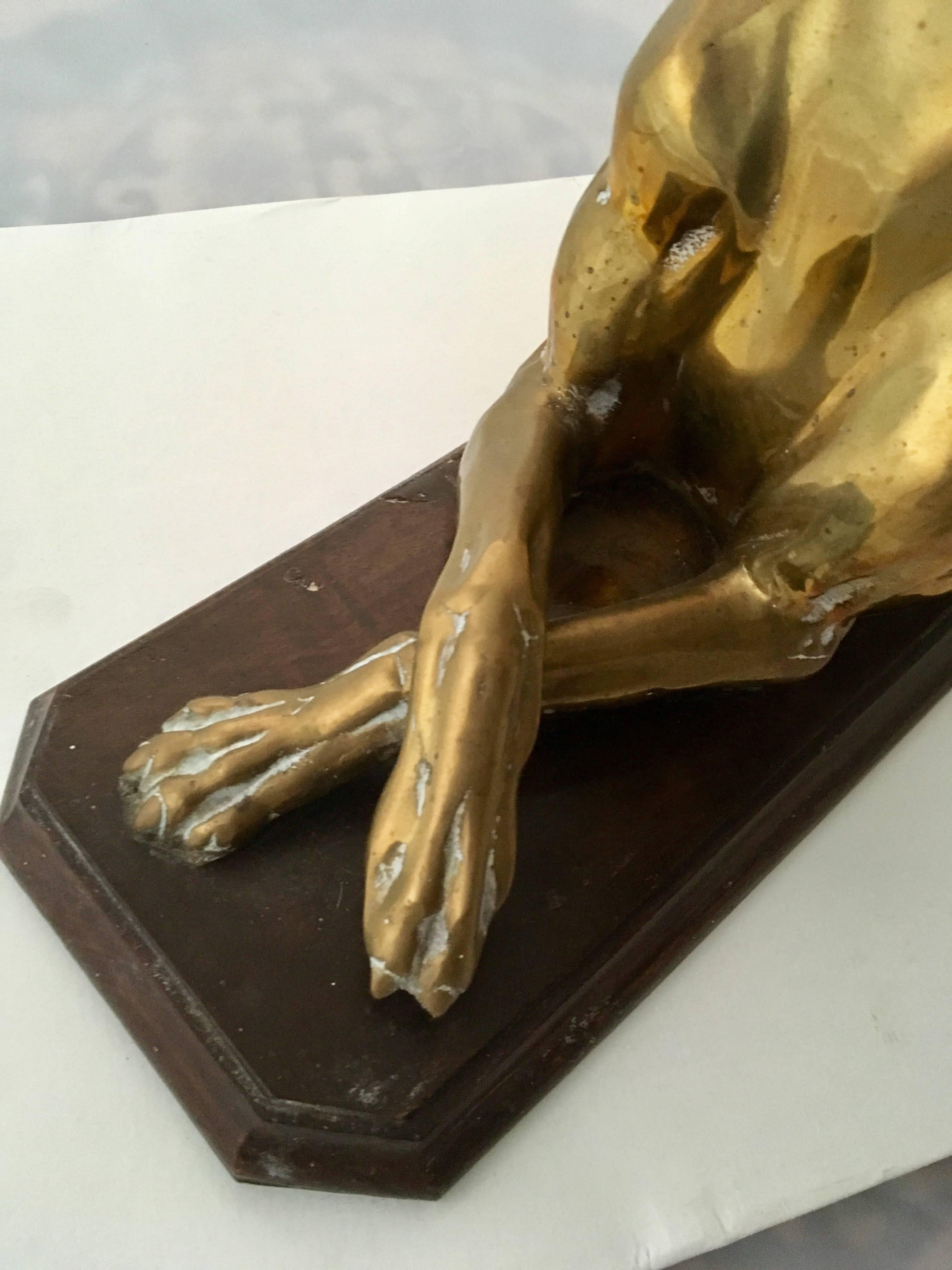 Art Deco brass sculpture of a whippet or greyhound, mounted on original mahogany base. Fine detail. A centerpiece sculpture, but could also be used as a door stop.