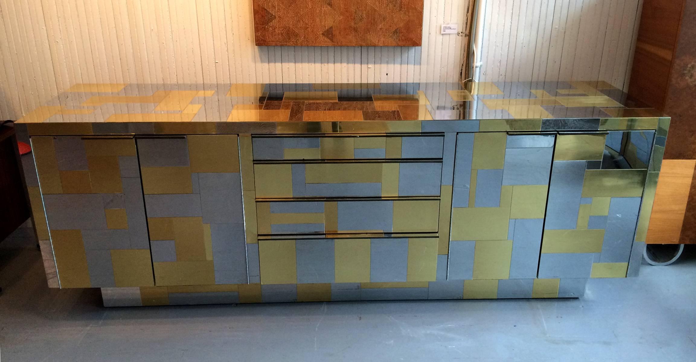 A stunning cityscape credenza or sideboard designed and crafted by Paul Evans for Directional, circa 1970s. The piece is of an impressive large size. Clad with hand-laid patchwork of chromed steel and brass panels, with very artistic patterns, the