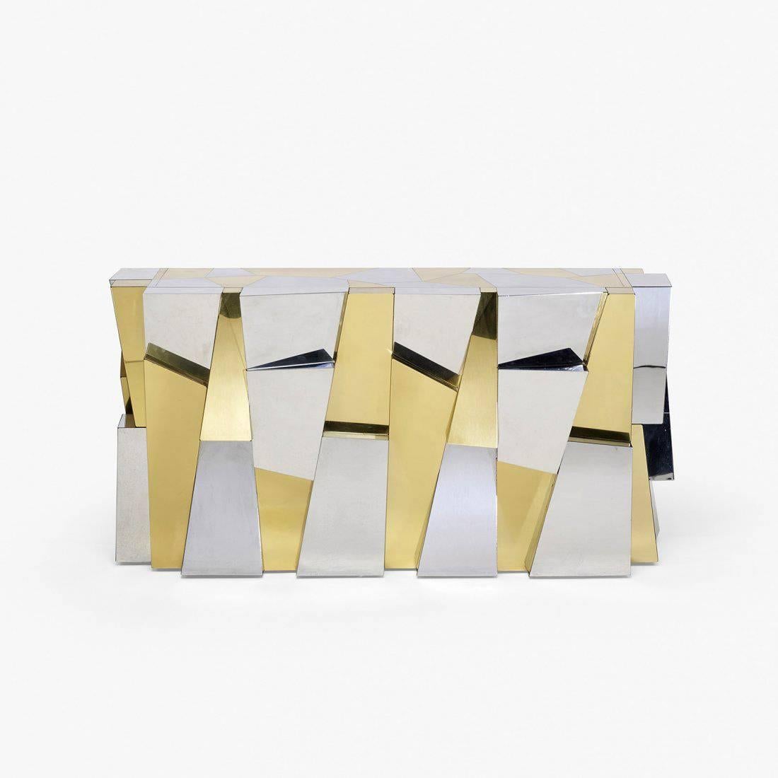A fantastic console table in the rare faceted Cityscape form, originally ordered directly from The Directional Showroom in the Merchandise Mart Chicago and studio made by Paul Evans. Contrasting brass and chromed steel in dramatic sculptural form.