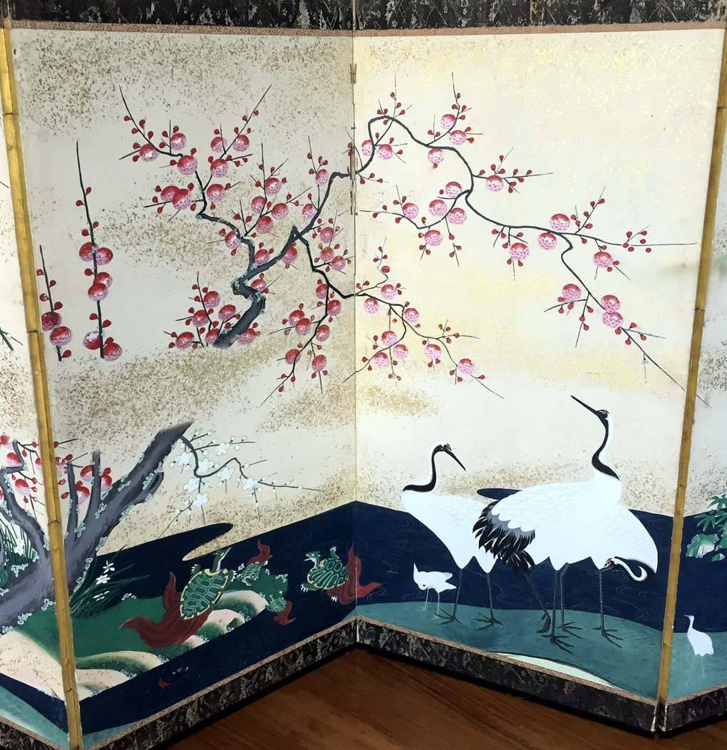 An amazing pair of matching antique Japanese folding screen predating 1812-1813, most likely from Kano School. Six panels each depict Chinese-inspired landscapes showing cranes, pines, peonies, cherry blossoms, mountains and water, all symbols of