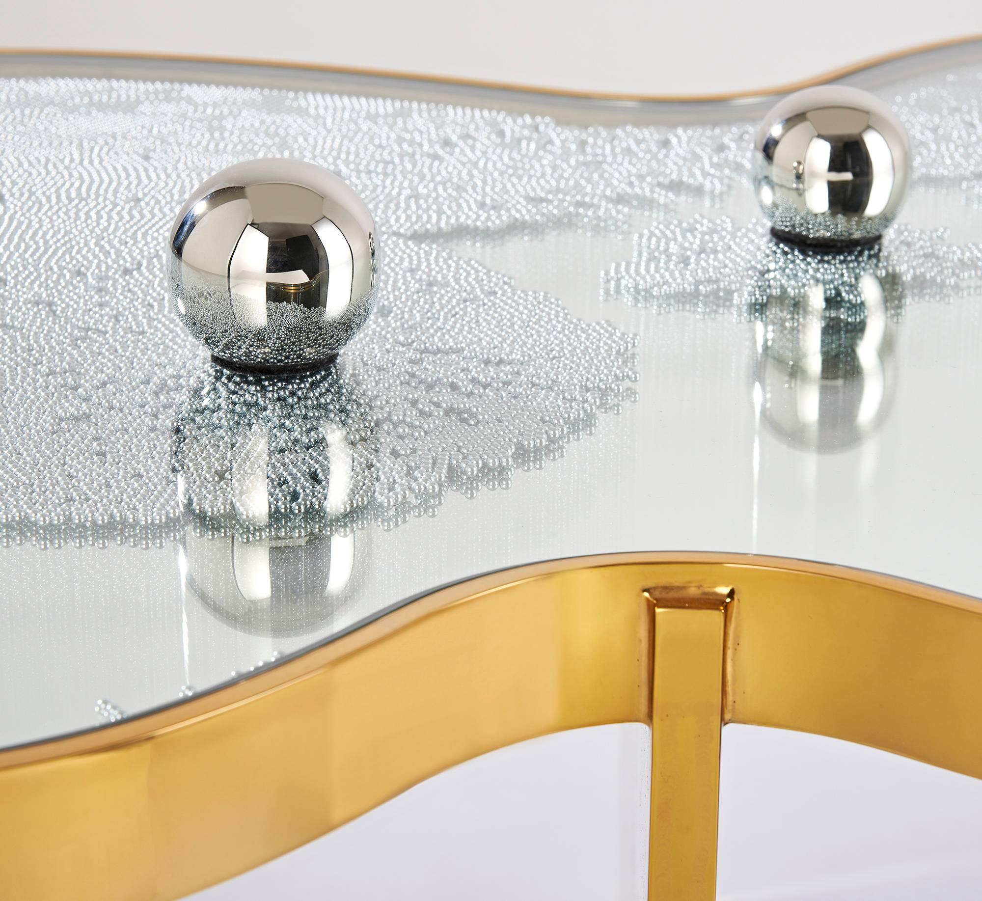 Mirror polished bronze.
Glass.
Steel ball bearings, magnets,

Limited Edition of 8.
2014.

Hubert le Gall's work is a bold combination of sophisticated and playful. Inspired by the likes of Salvador Dali, Jean Cocteau, the Surrealists and Max Ernst,