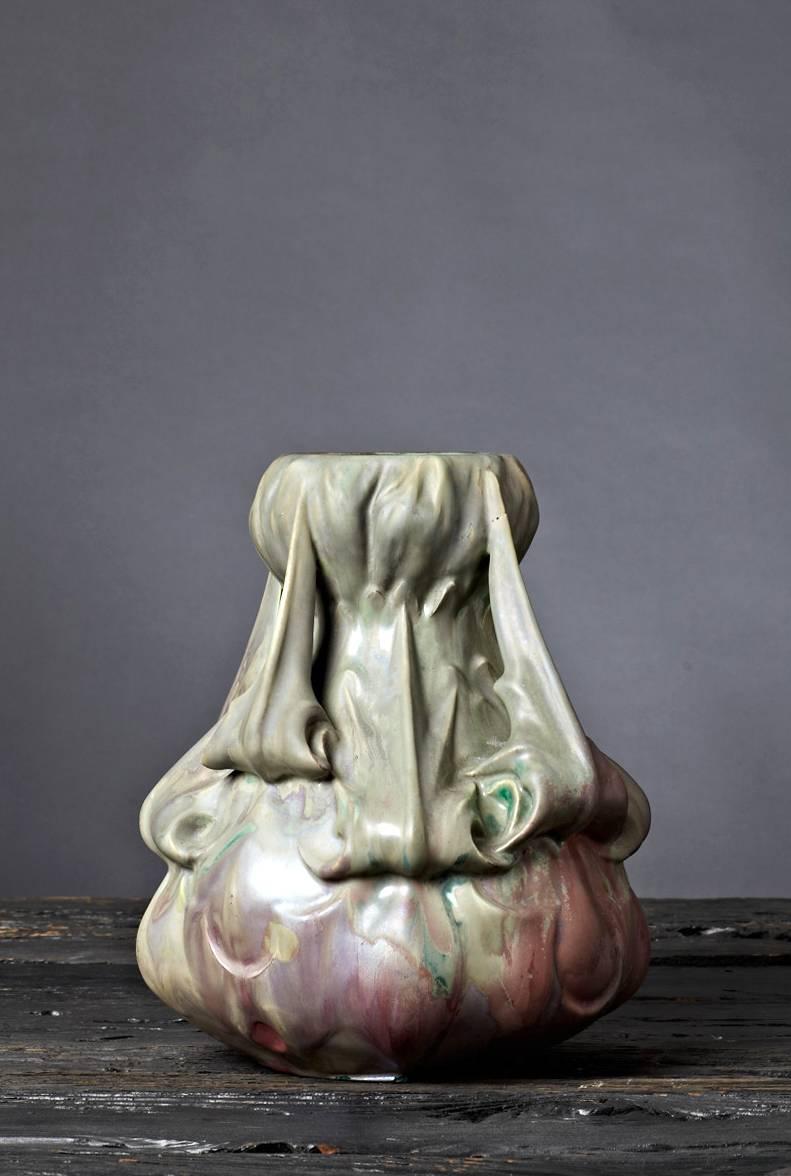 Designed by Ernest Bussière and produced by the Luneville firm of Keller & Guerin, this stunning vase exemplifies the Art Nouveau emphasis on stylized organic shapes. Both the sculptural treatment and the unusual blending of purple and green mat