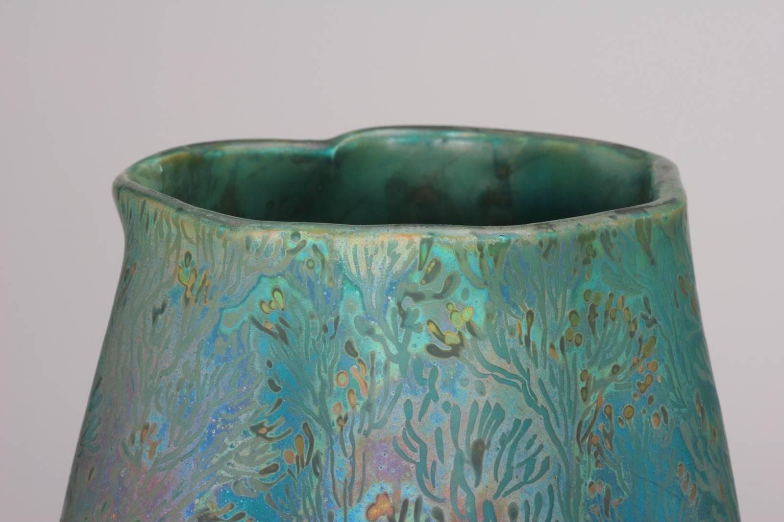 Photography does not do justice to the complexity of the glaze on this remarkable ceramic masterpiece. The luster varies from Persian turquoise to pink, red, green, gold and every tone in between. An active world of shrimp, seaweed and other sea