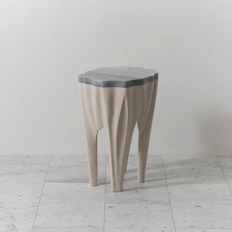 At once a unique standing sculpture and functional object, Markus Haase's ash and marble side table epitomizes the sculptor's distinct approach to fluidly melting stone and wood together.

The artist's two decades of experience as a sculptor are